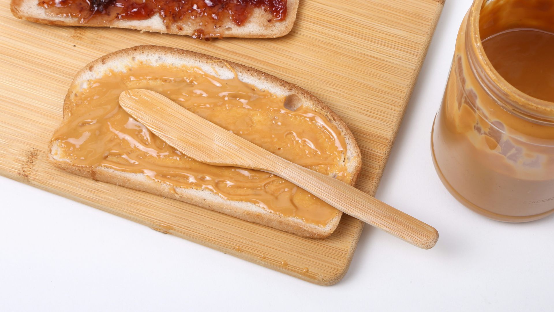 a wooden spoon next to a bowl of food