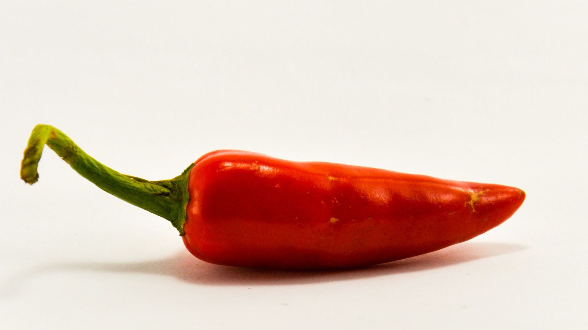 red chili on white surface