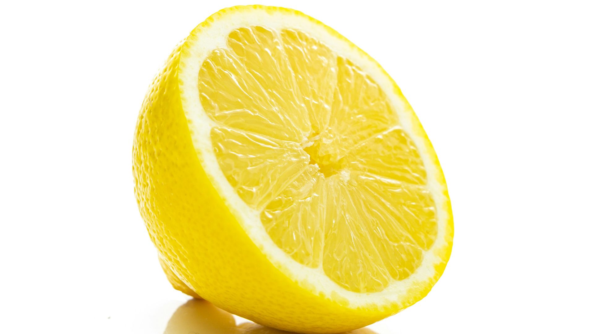 yellow lemon fruit on white surface