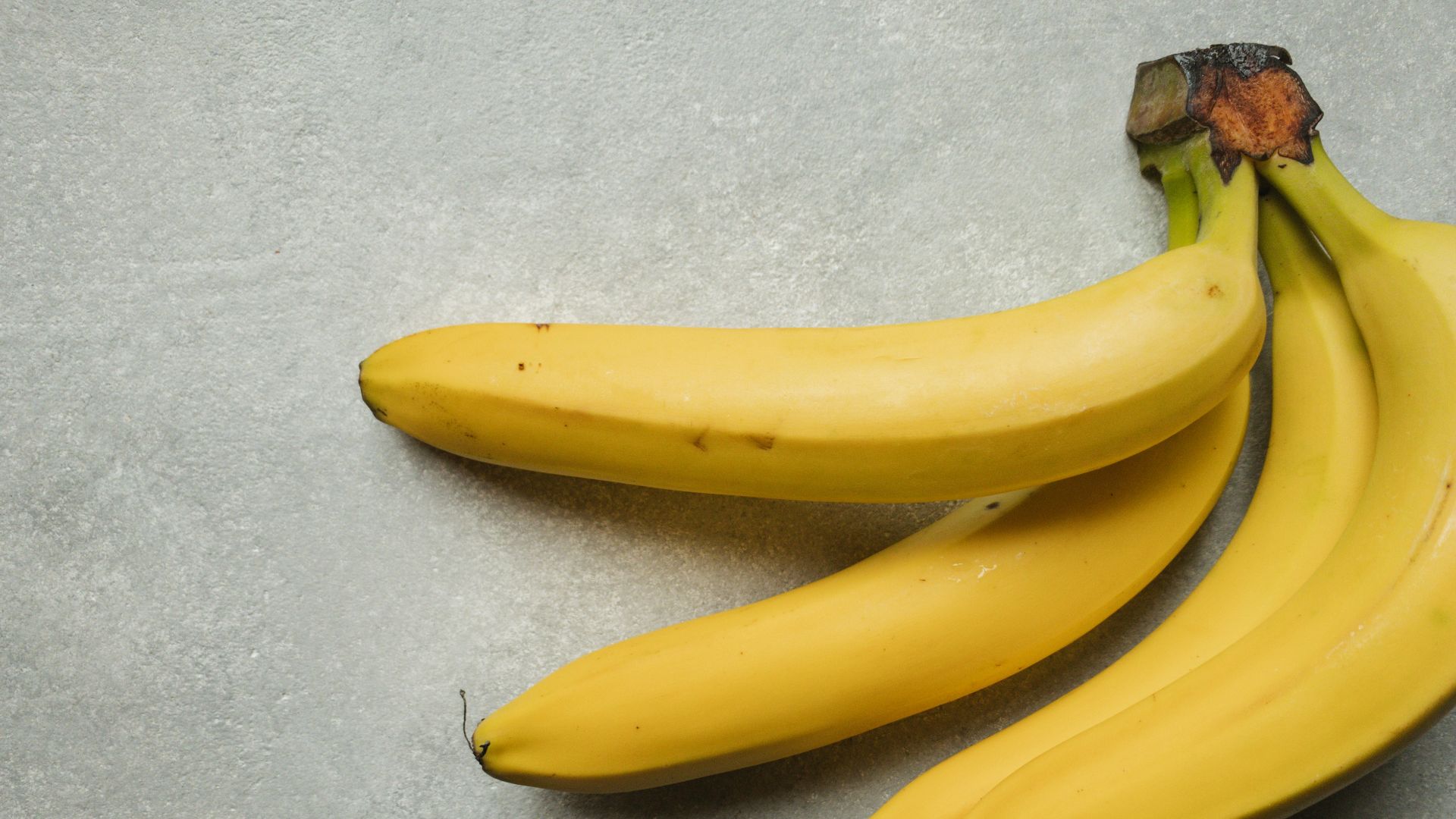 yellow banana fruit on gray table