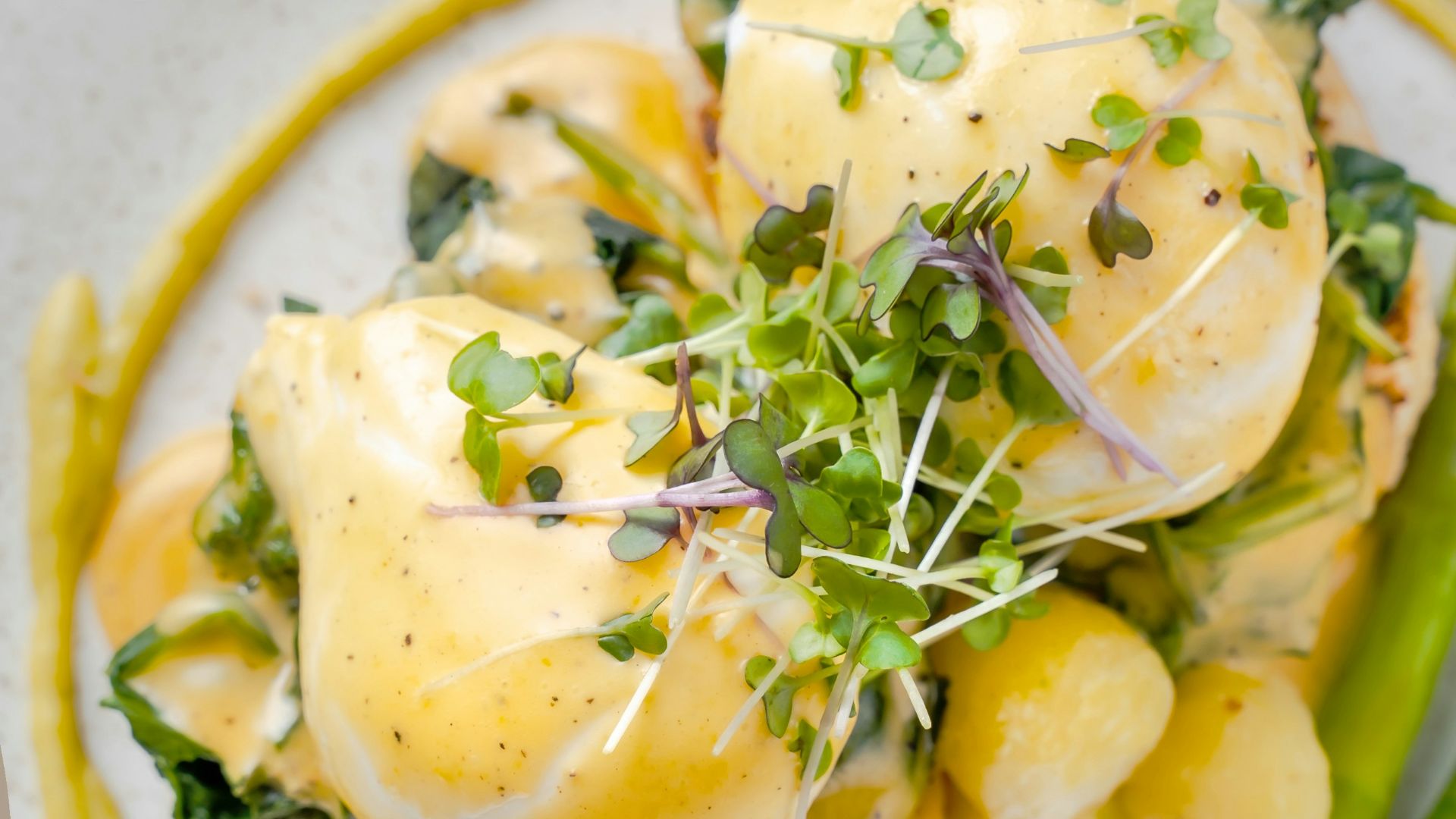 a plate of food with asparagus and eggs
