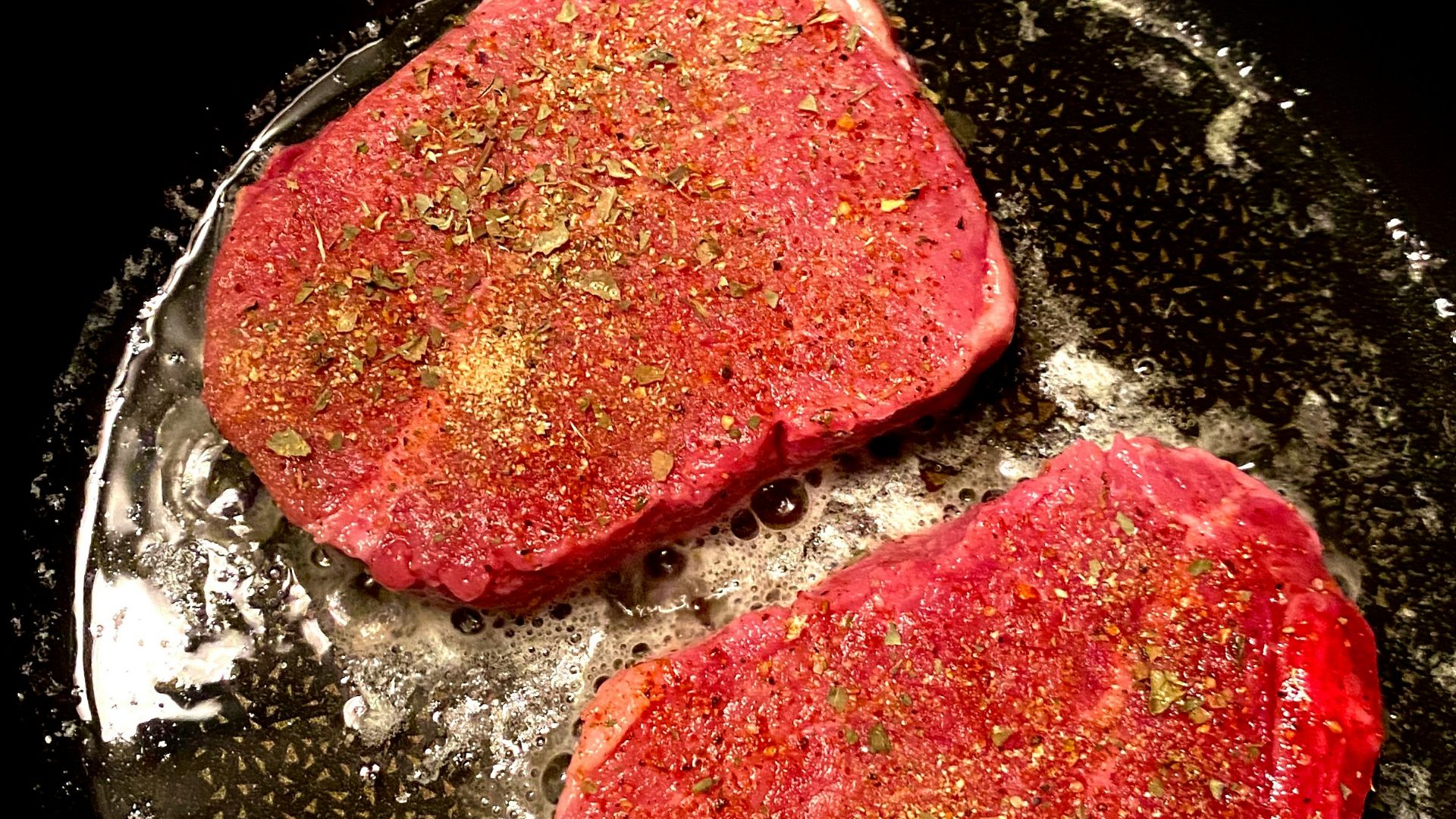 red and black dish on black pan