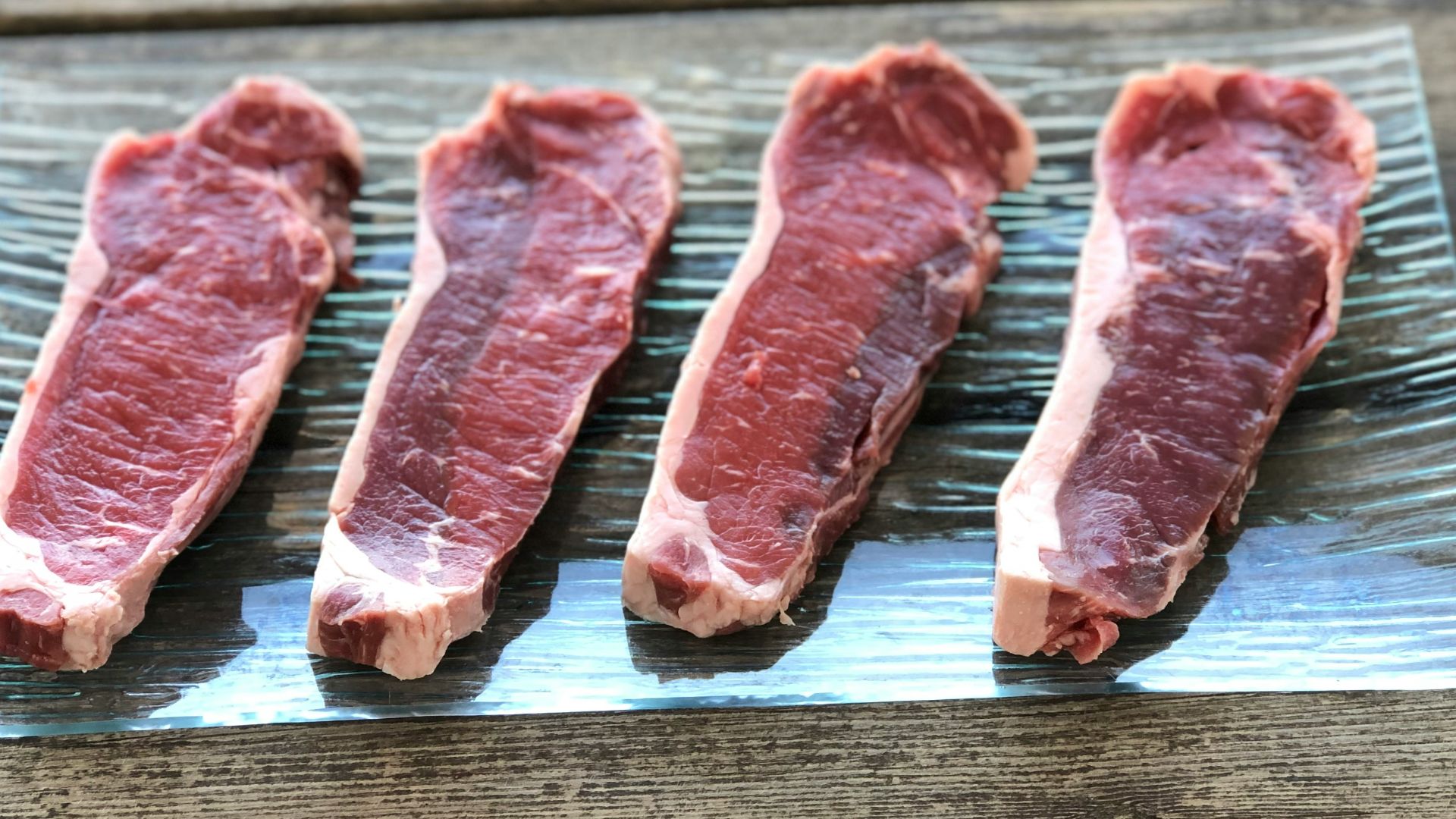 four raw meats on plastic pack