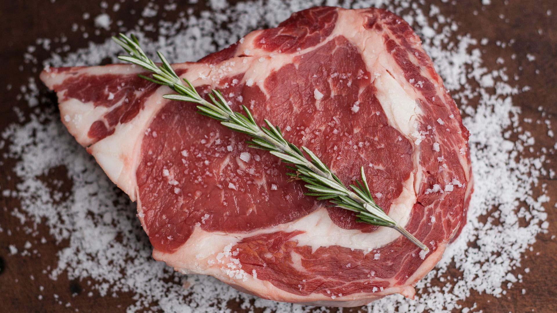 raw meat on brown wooden table