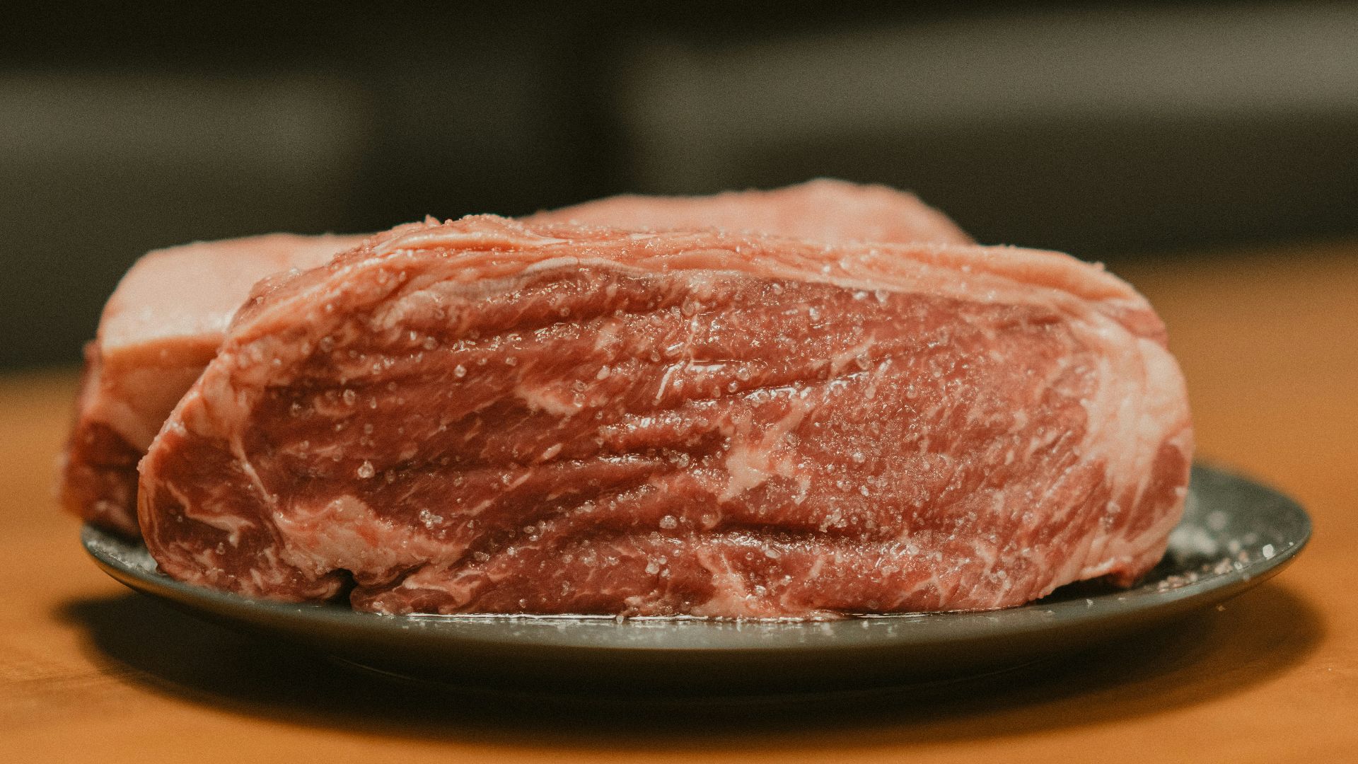 A piece of meat on a plate on a table
