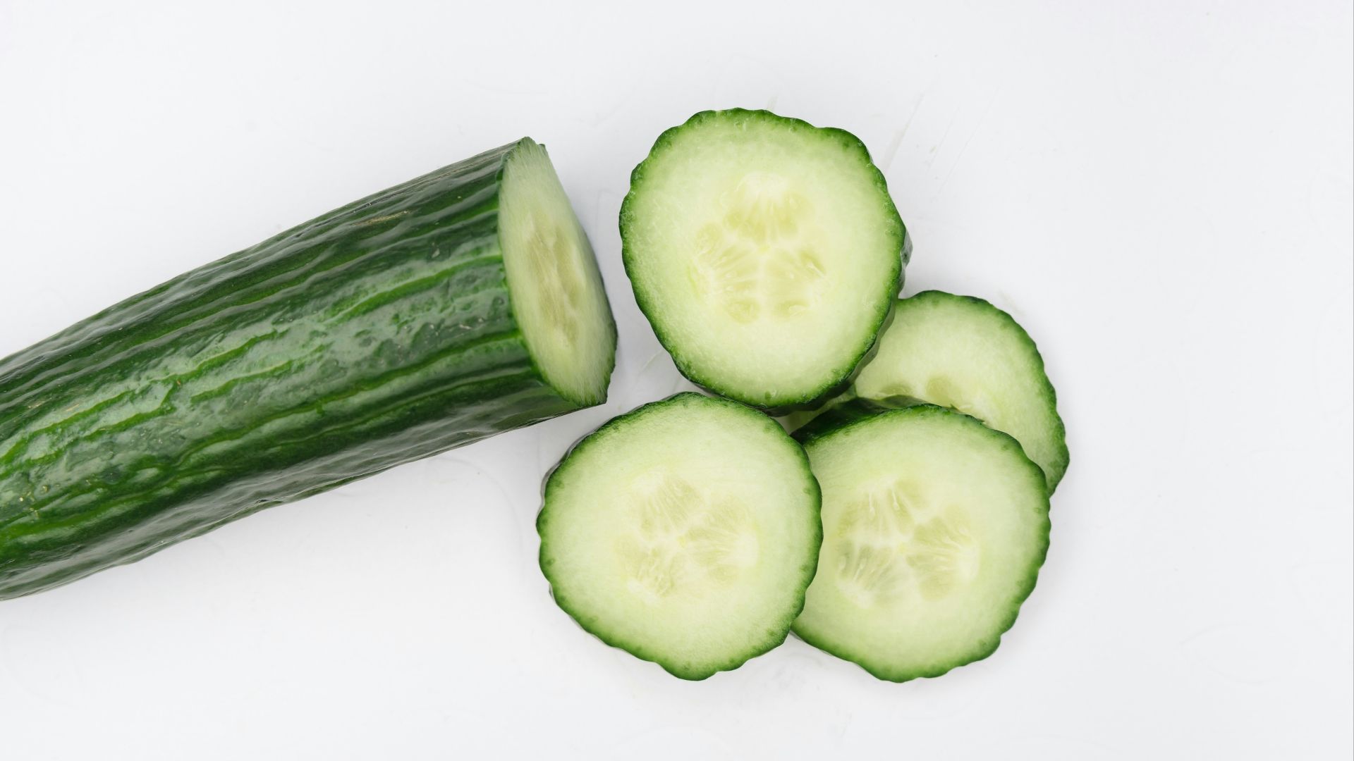 sliced cucumber on white surface