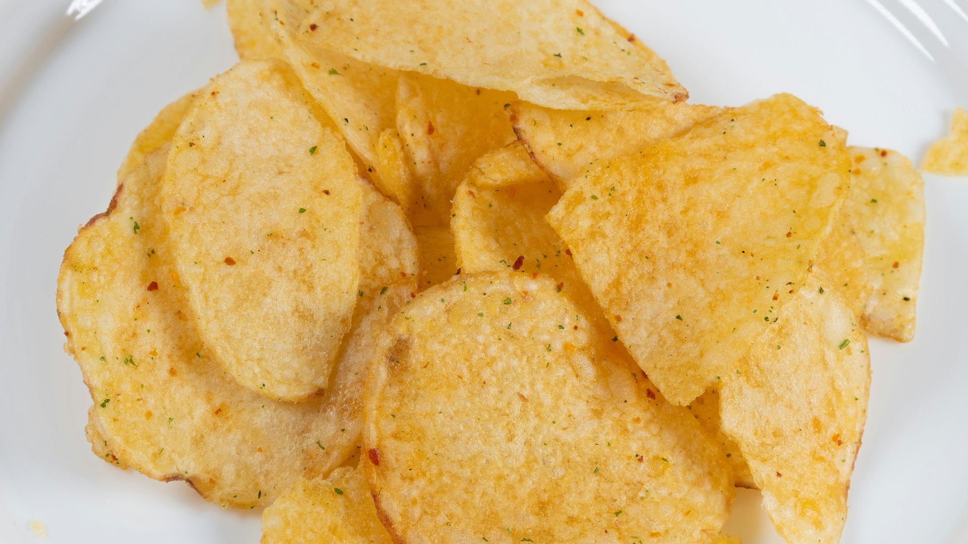 a white plate topped with chips on top of a table