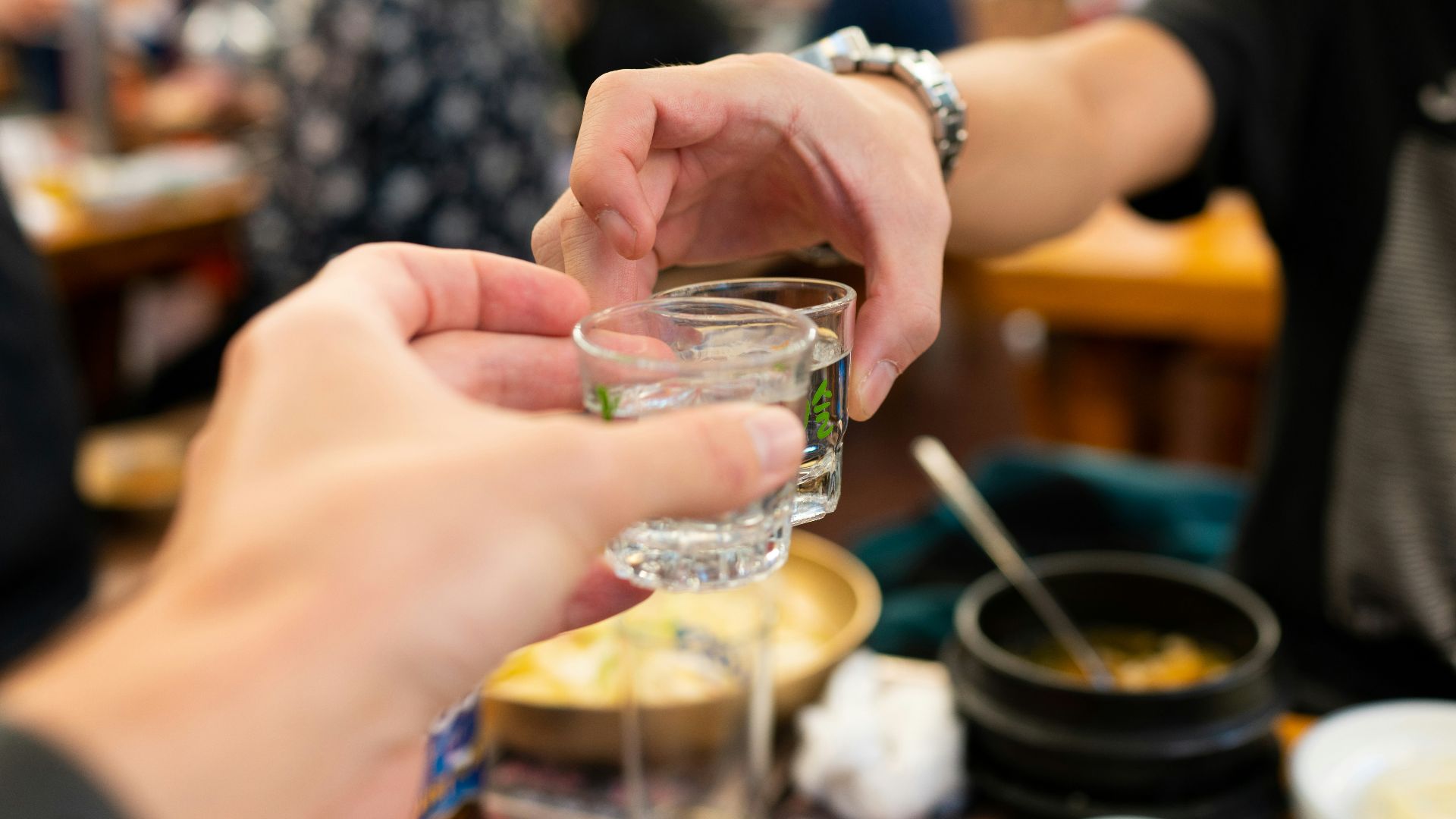 person holding clear drinking glass with water
