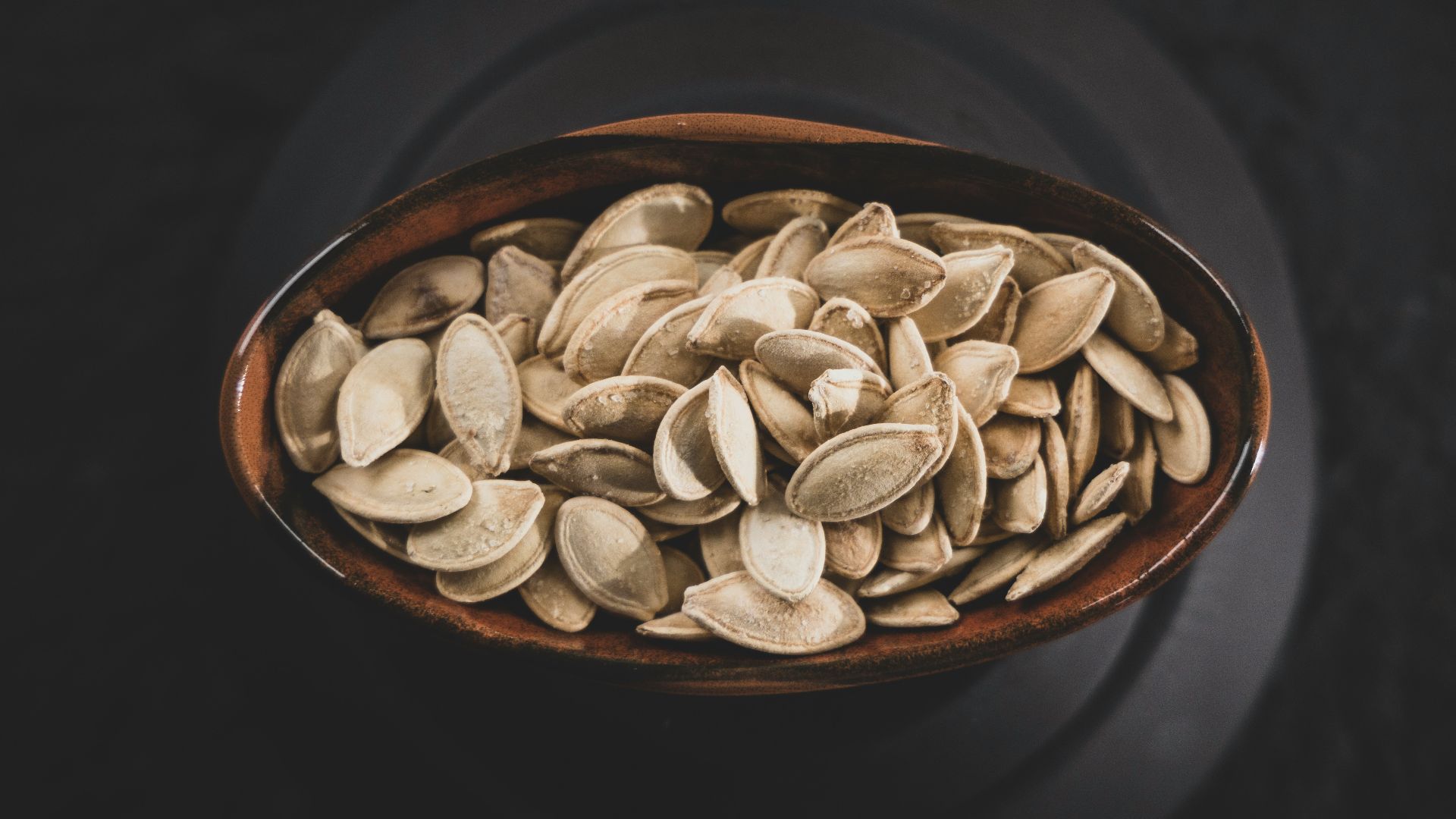 brown and white nuts on brown ceramic bowl