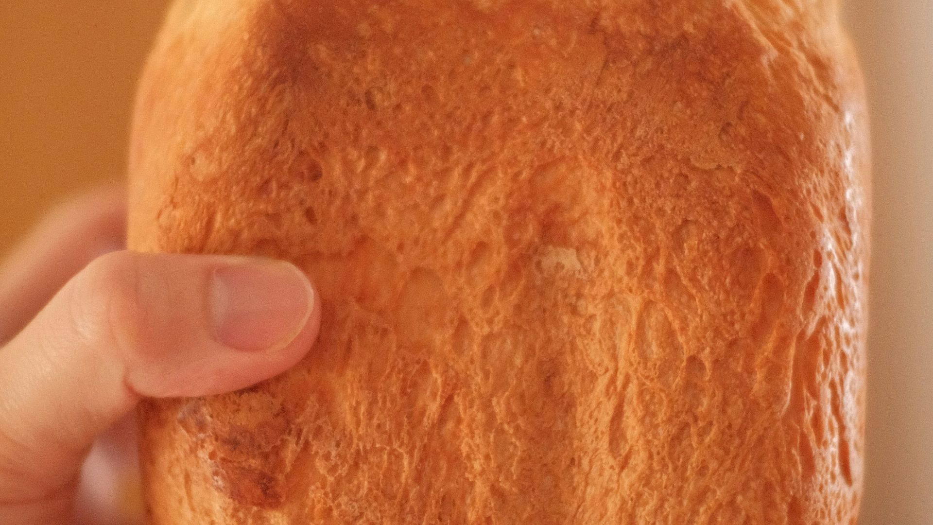 person holding bread with butter