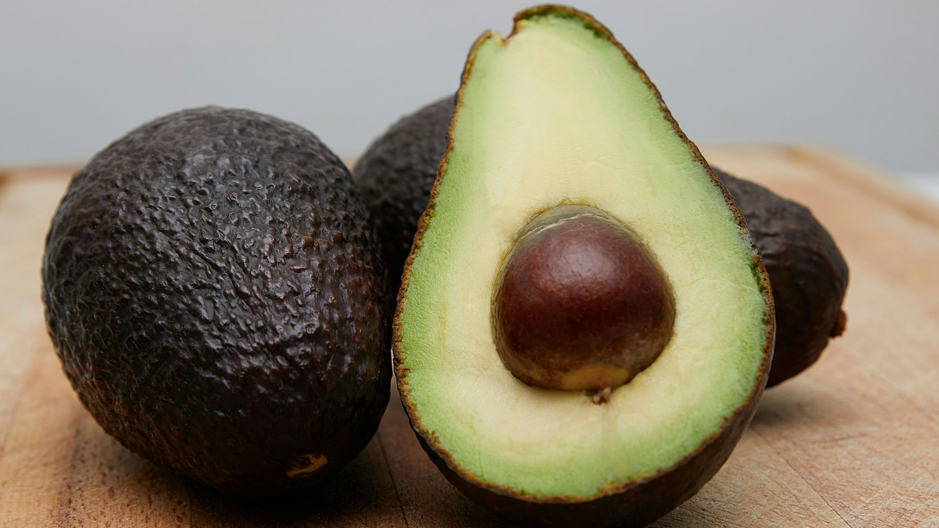 sliced avocado fruit on brown wooden table