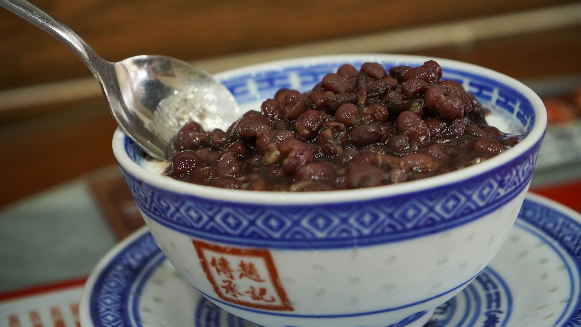 a bowl of beans with a spoon in it