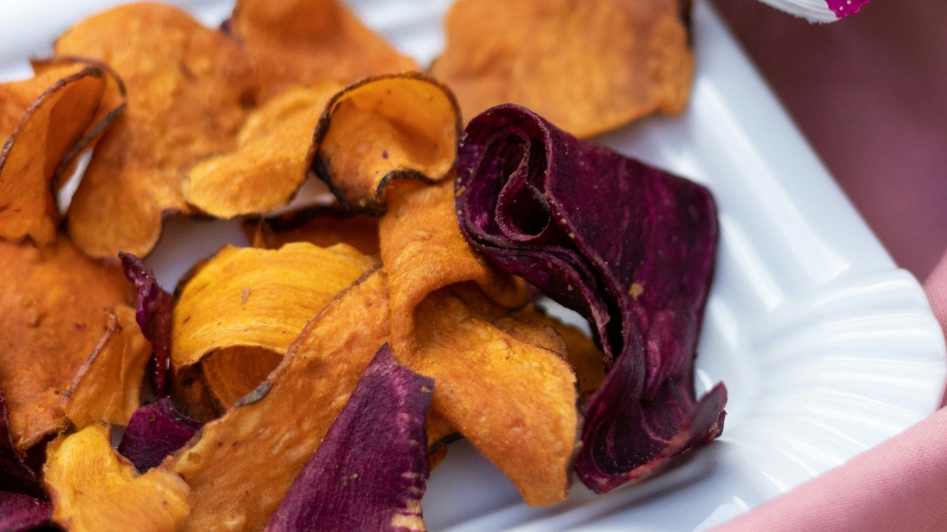a white plate topped with chips next to a bag of chips