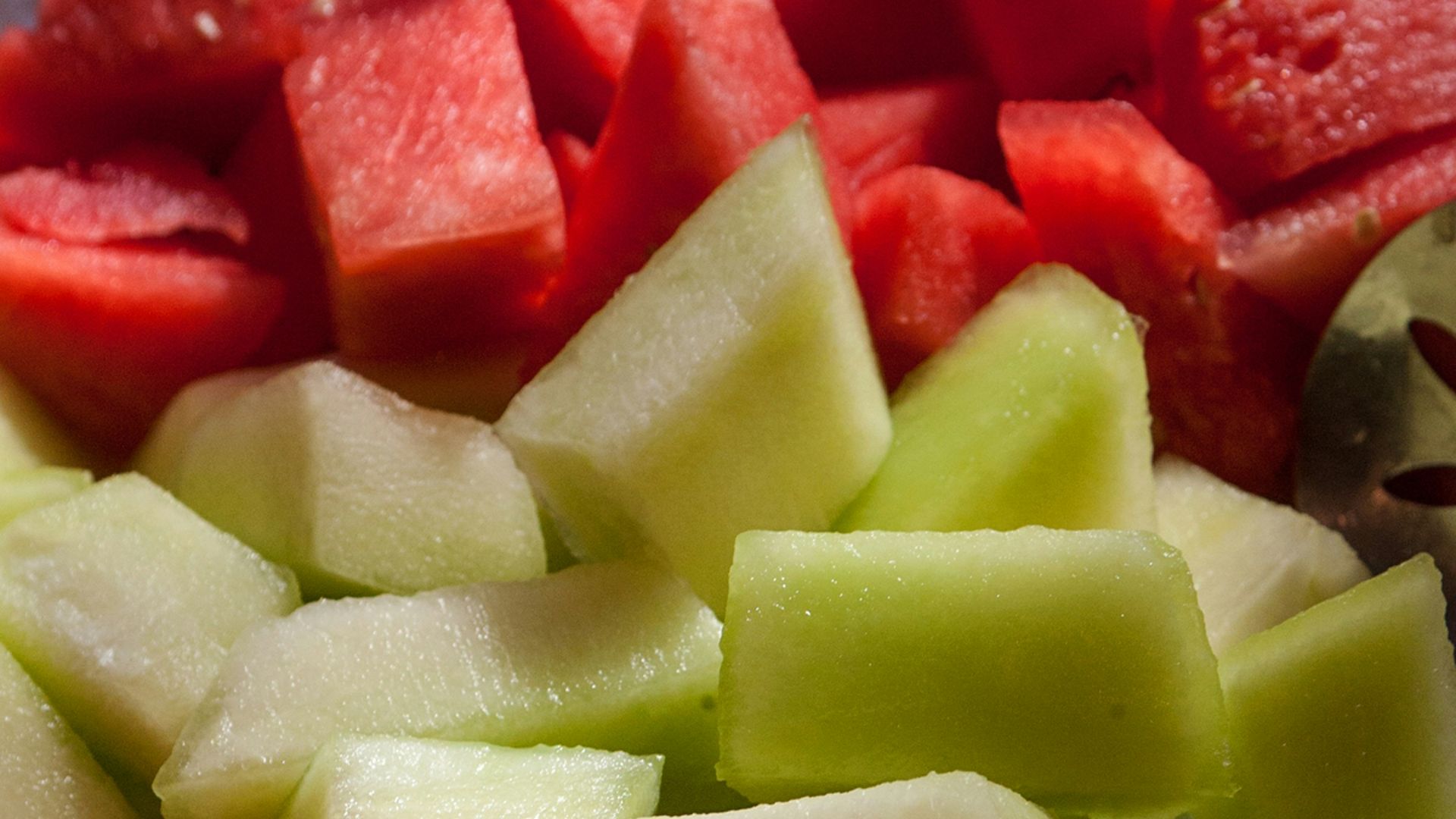 a close up of a plate of cut up fruit