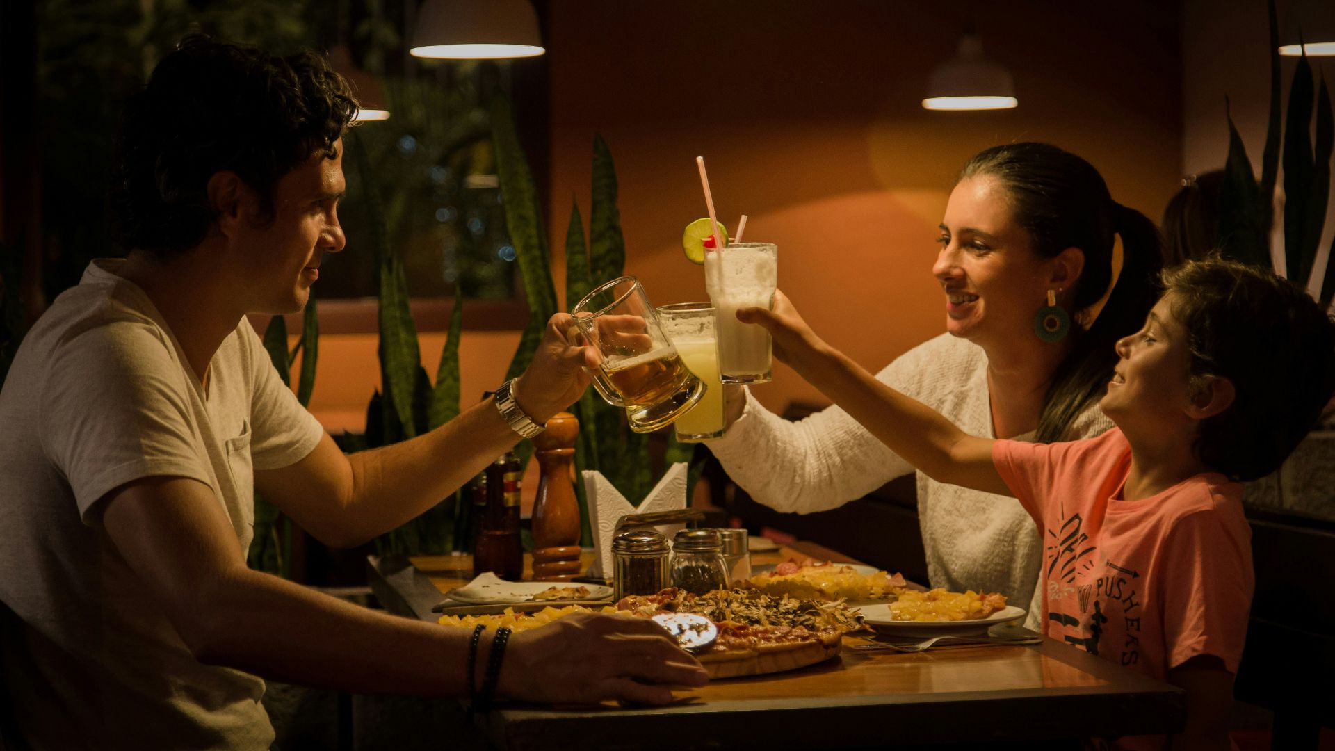 three people having a toast on table