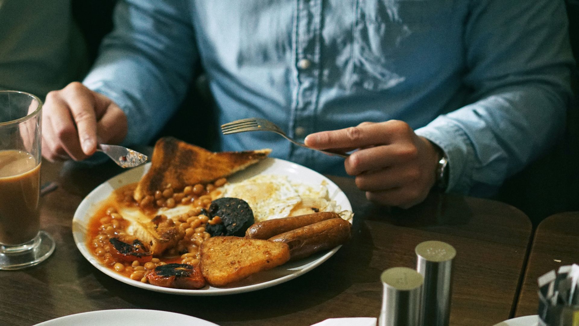 person eating bread with beans