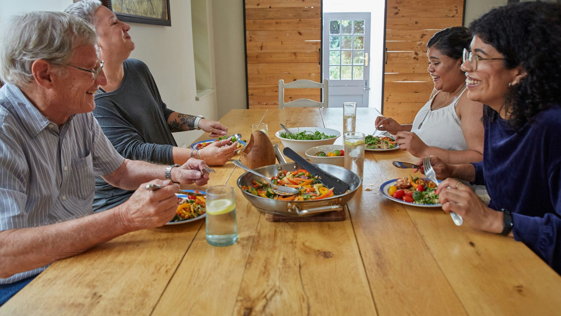 a group of people sitting around a table eating food