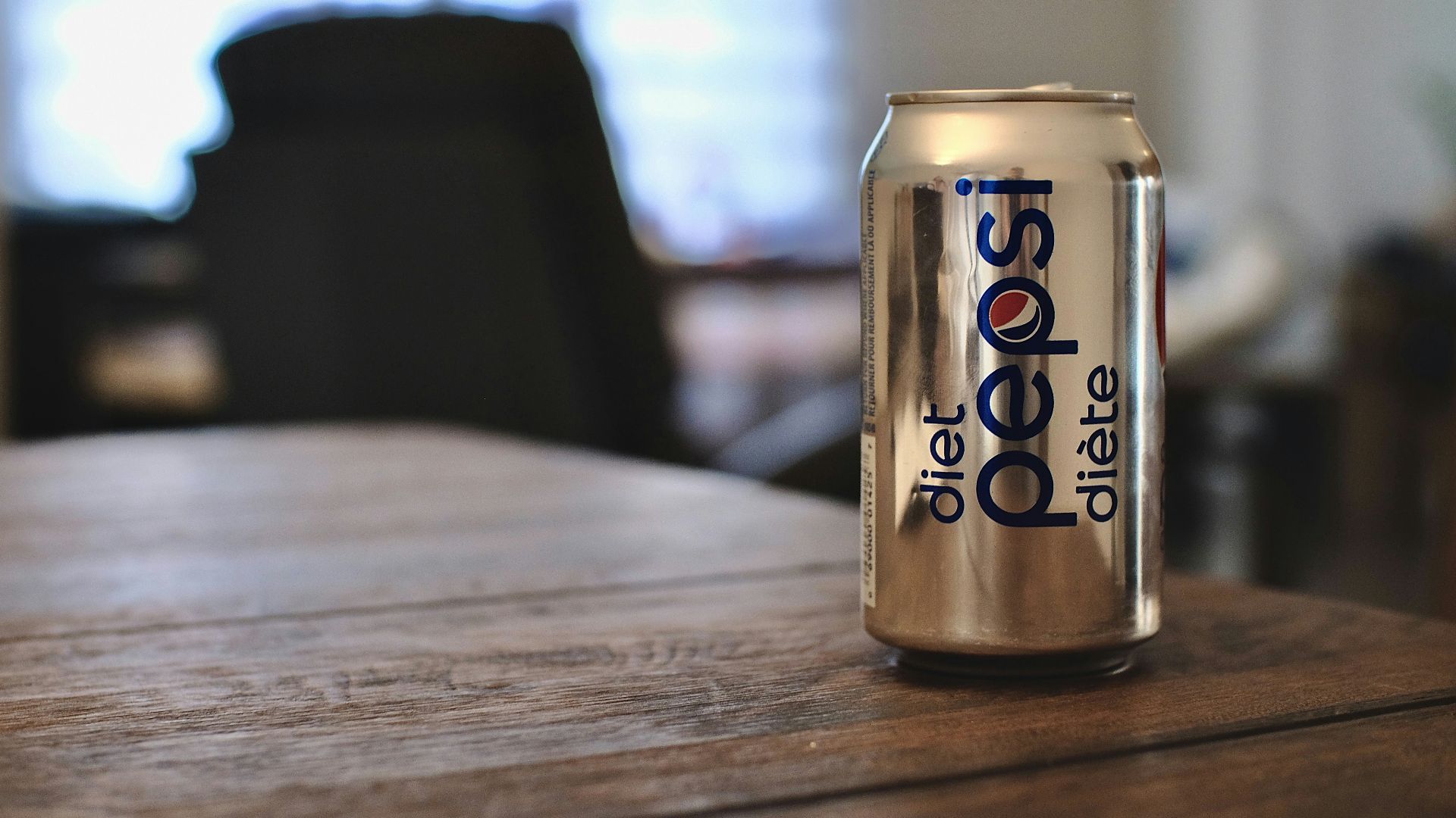 diet coke can on brown wooden table