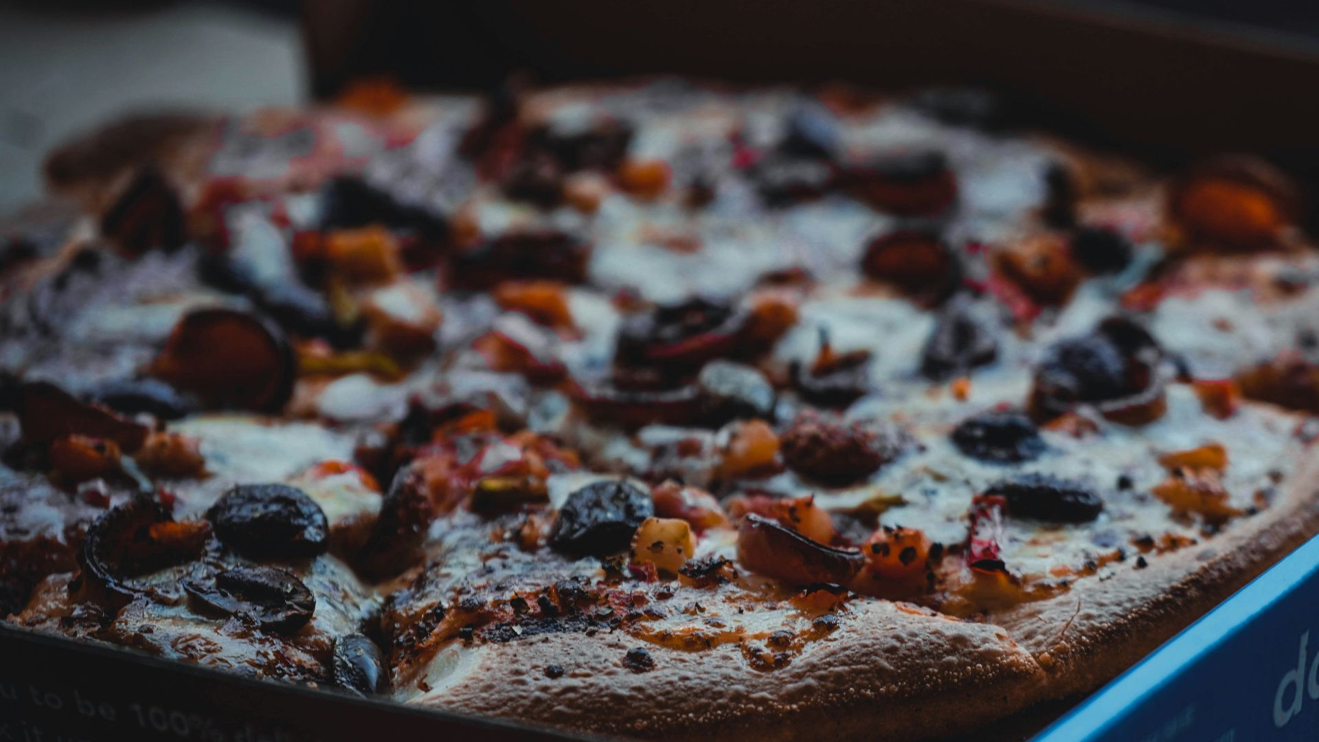a close up of a pizza in a box