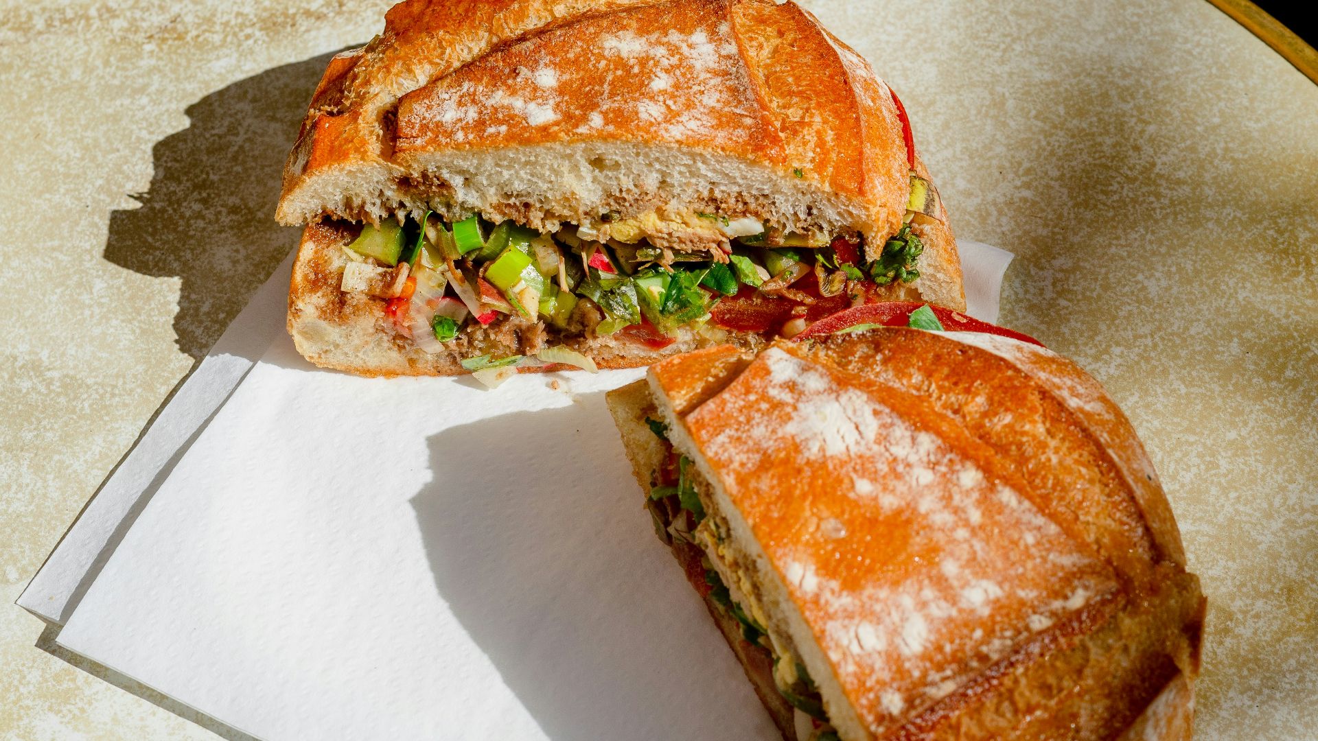 a sandwich cut in half sitting on top of a table