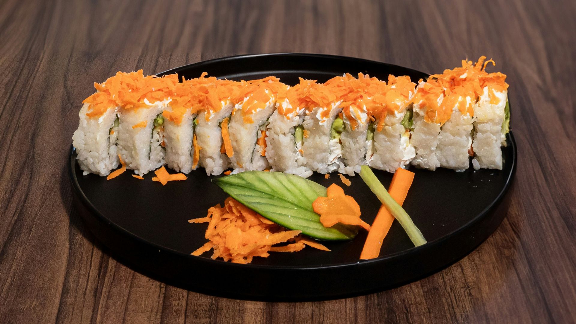 A plate of sushi on a wooden table