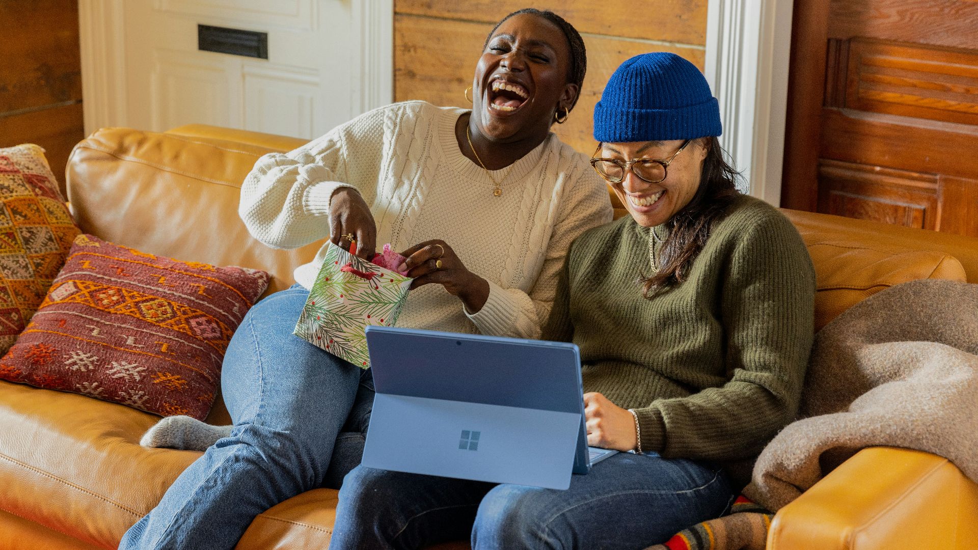 a person sitting on a couch with a laptop