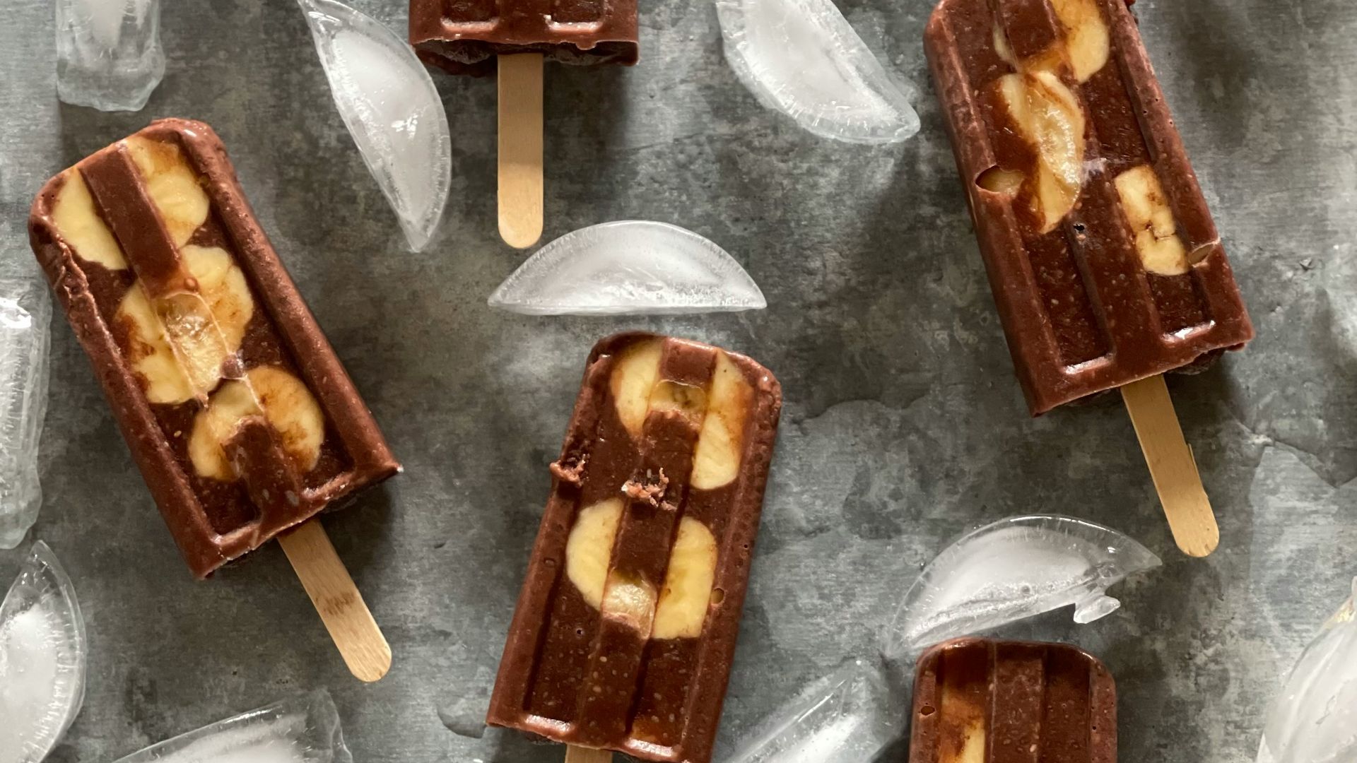 four pieces of chocolate and banana pops on ice