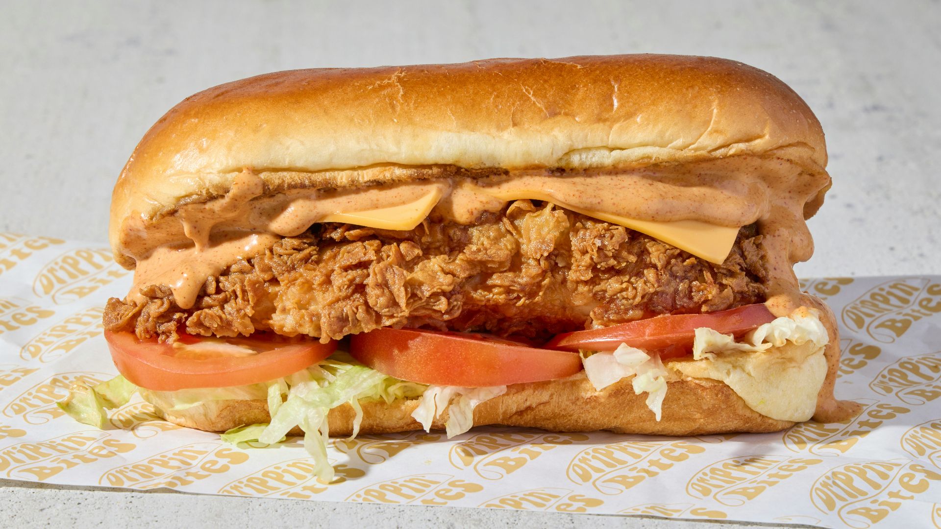 a fried chicken sandwich with lettuce and tomatoes