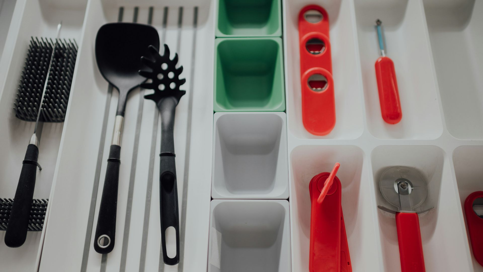 red handled spoon and fork on white plastic container