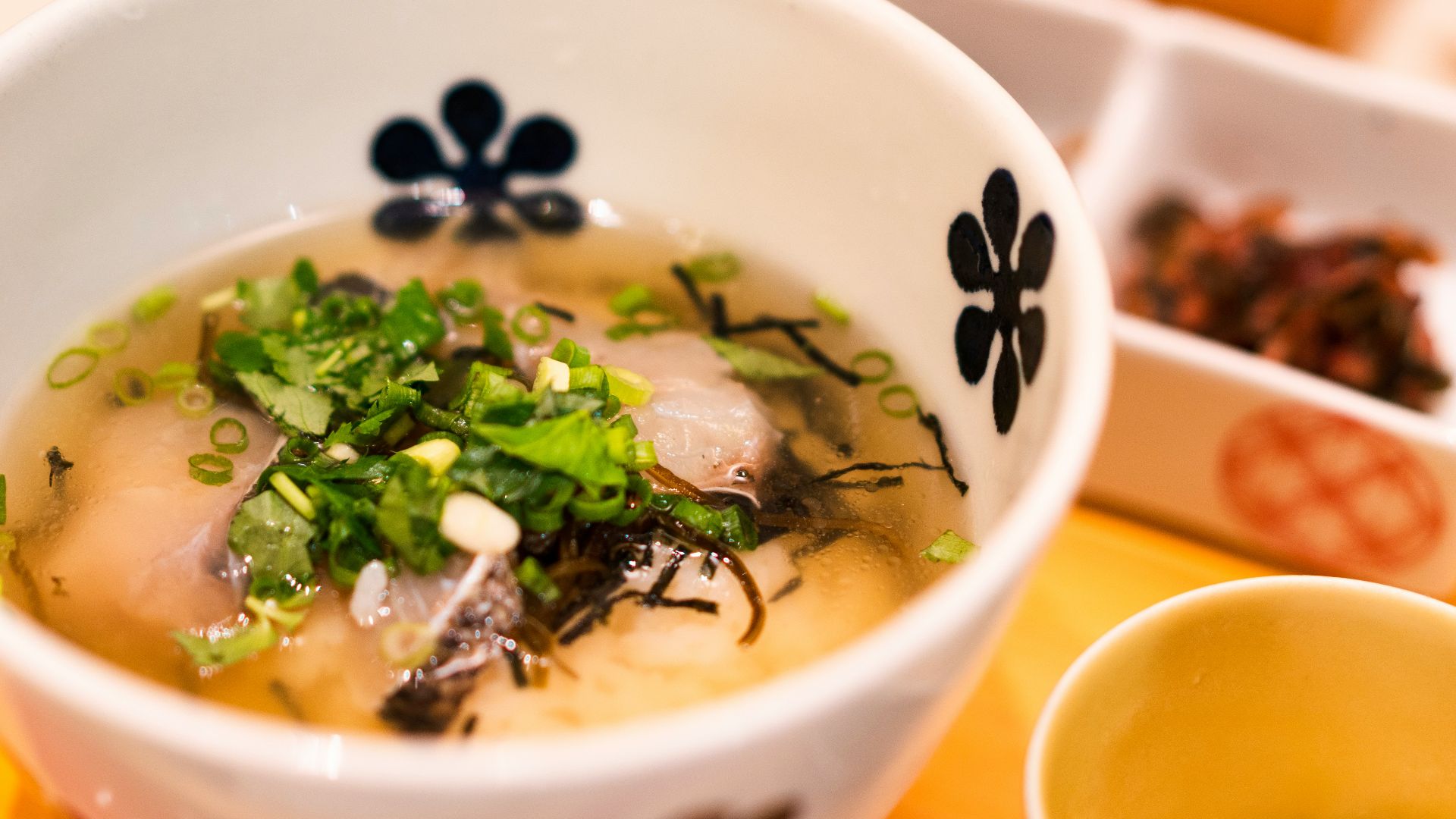white and blue ceramic bowl with soup