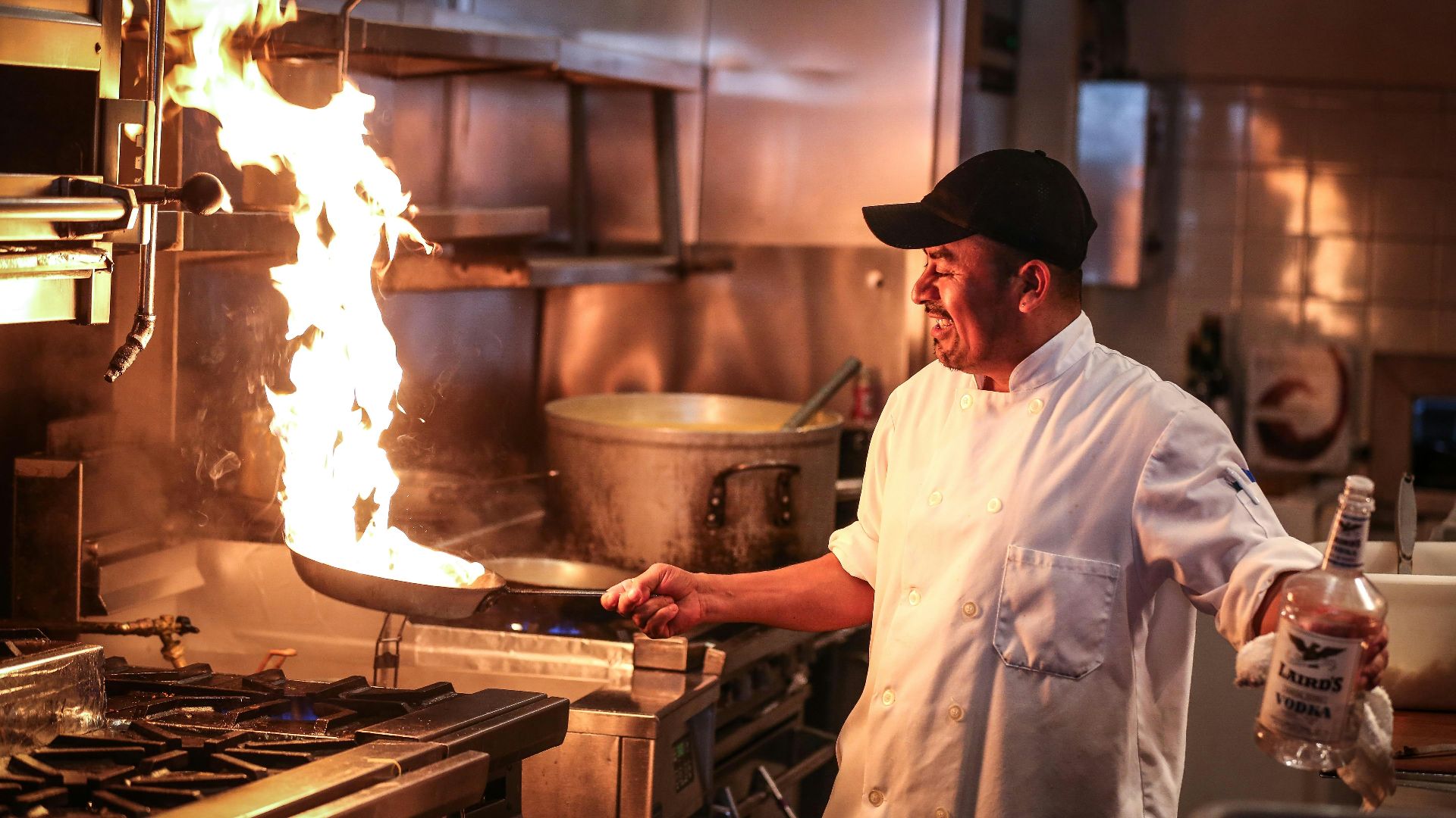 man in white chef uniform cooking