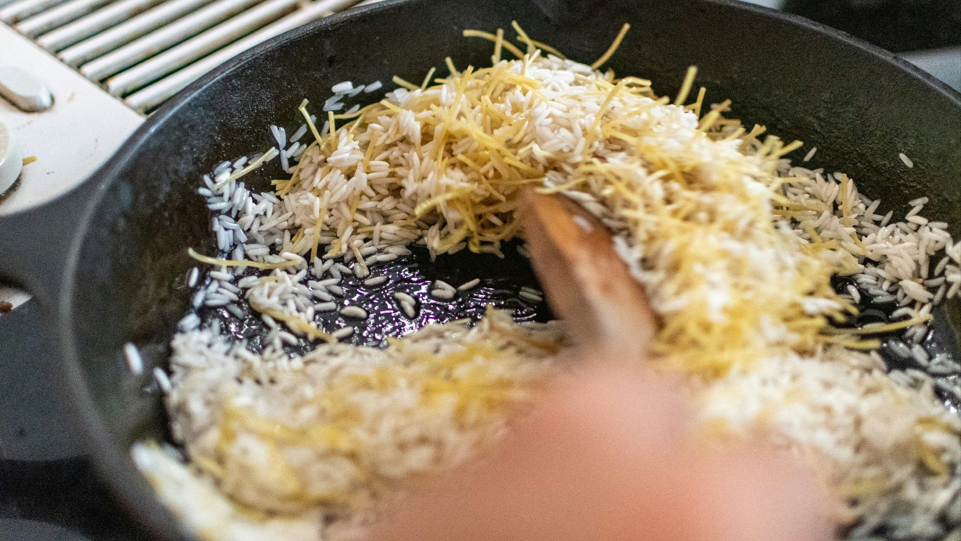 cooked rice on black frying pan