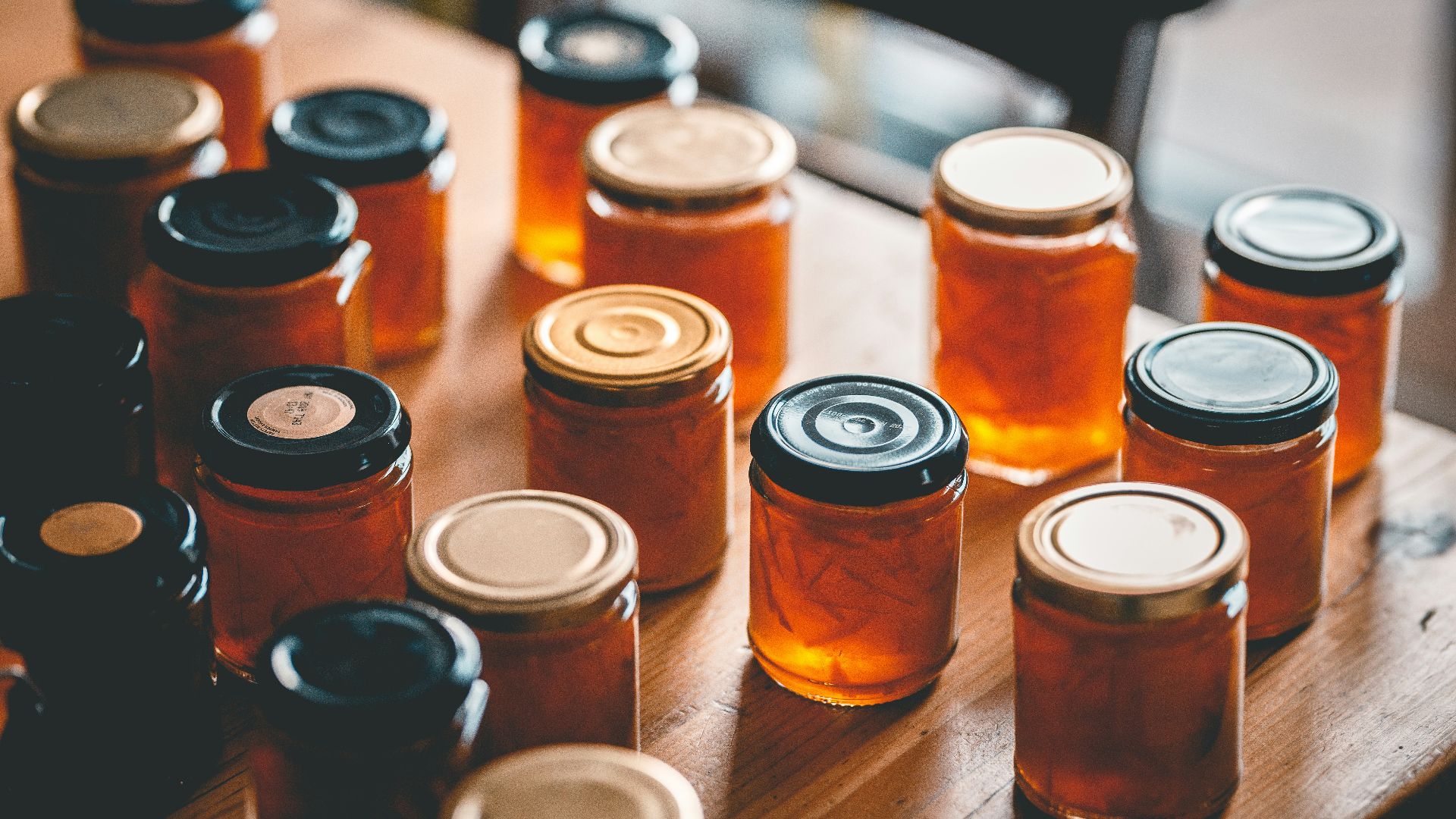 a table topped with lots of jars filled with liquid