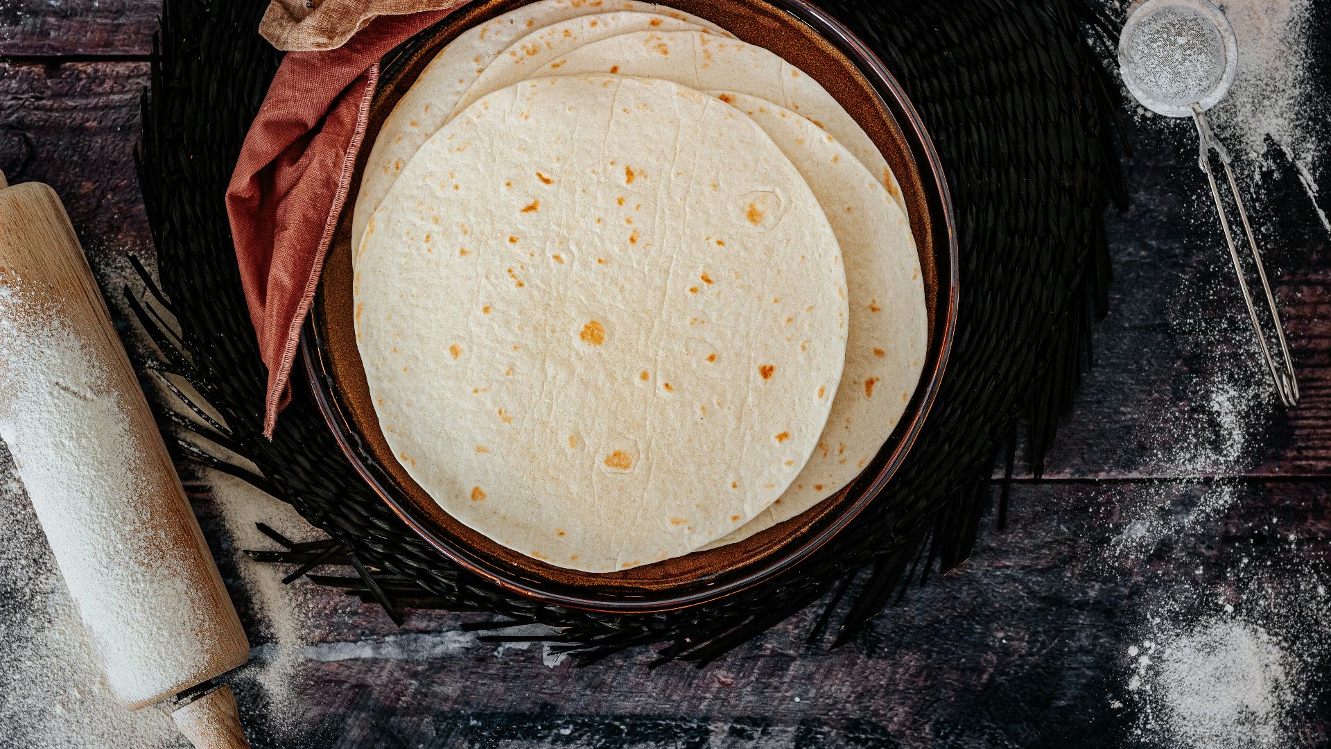 brown woven round basket on black and gray textile