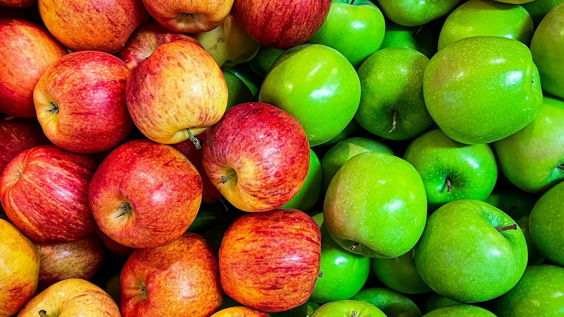 green and red apples on white plastic container