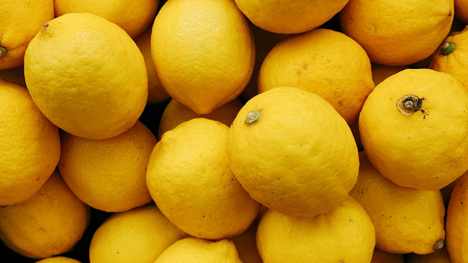 yellow citrus fruits on black surface