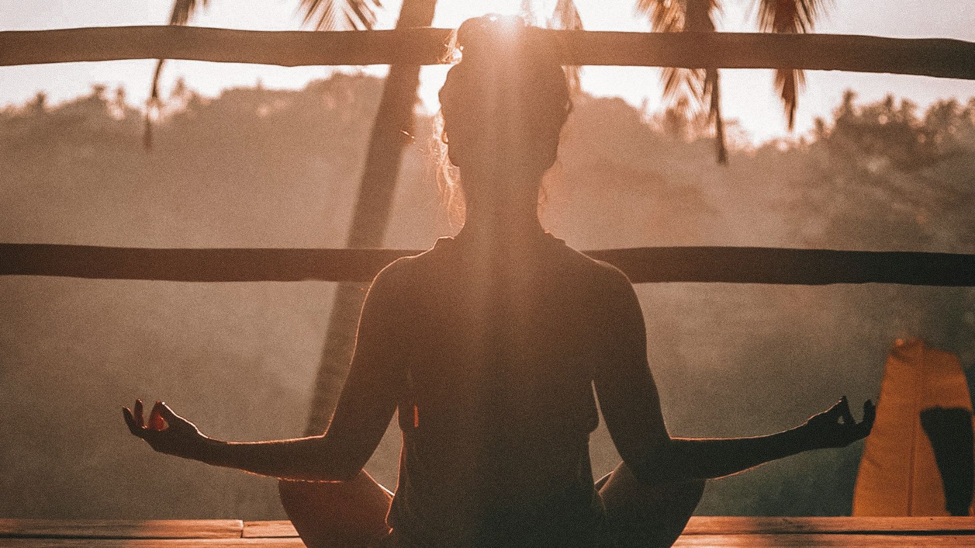 woman doing yoga meditation on brown parquet flooring