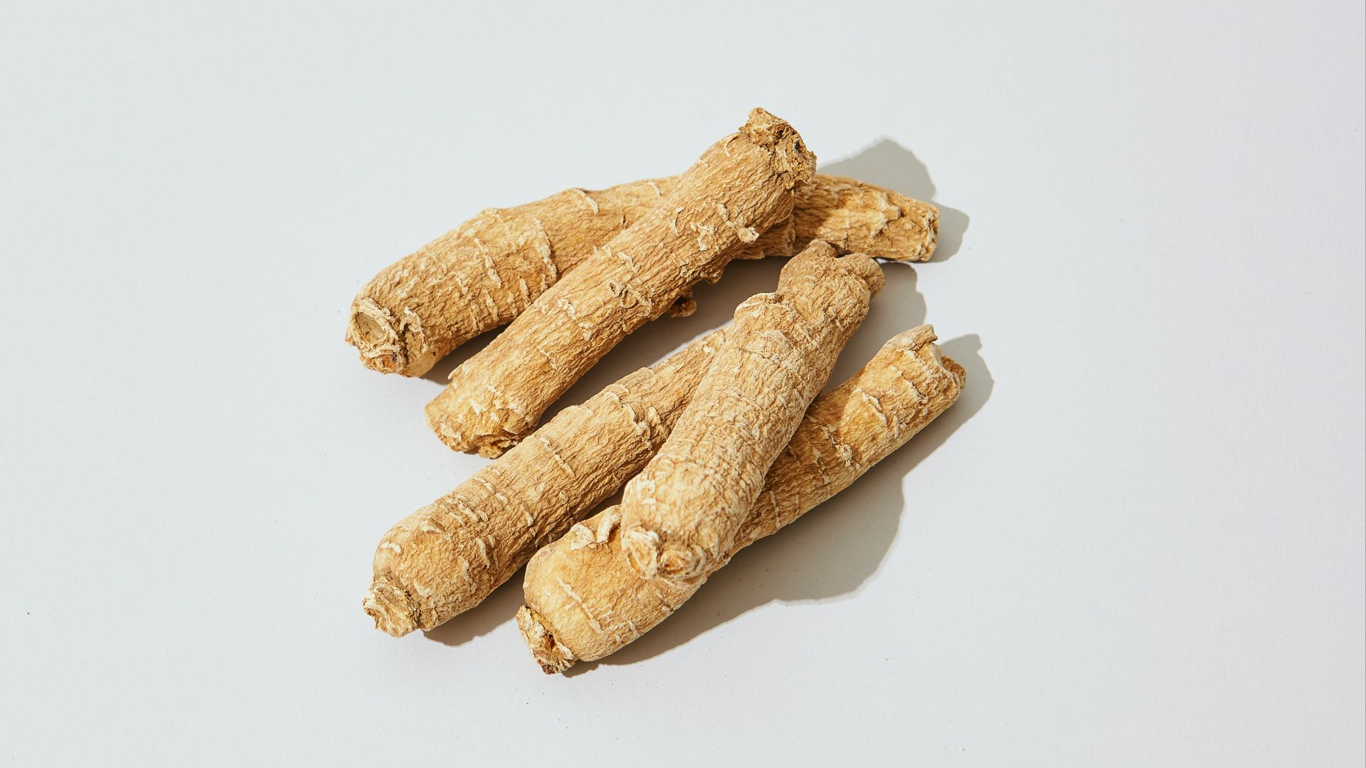 three pieces of ginger on a white surface