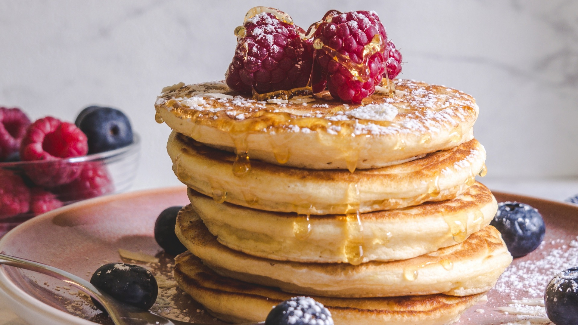 pancakes with berries on white ceramic plate