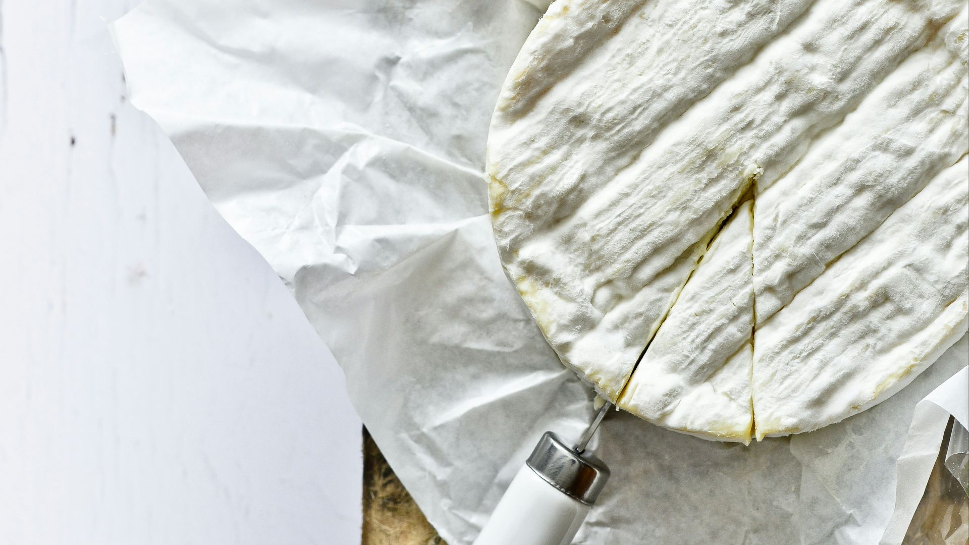 white and blue round container on white textile