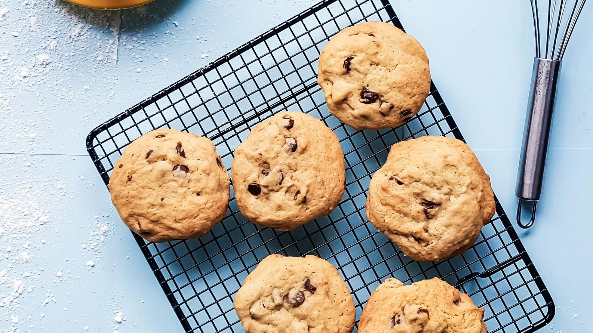 cookies on black grill beside yellow ceramic cup