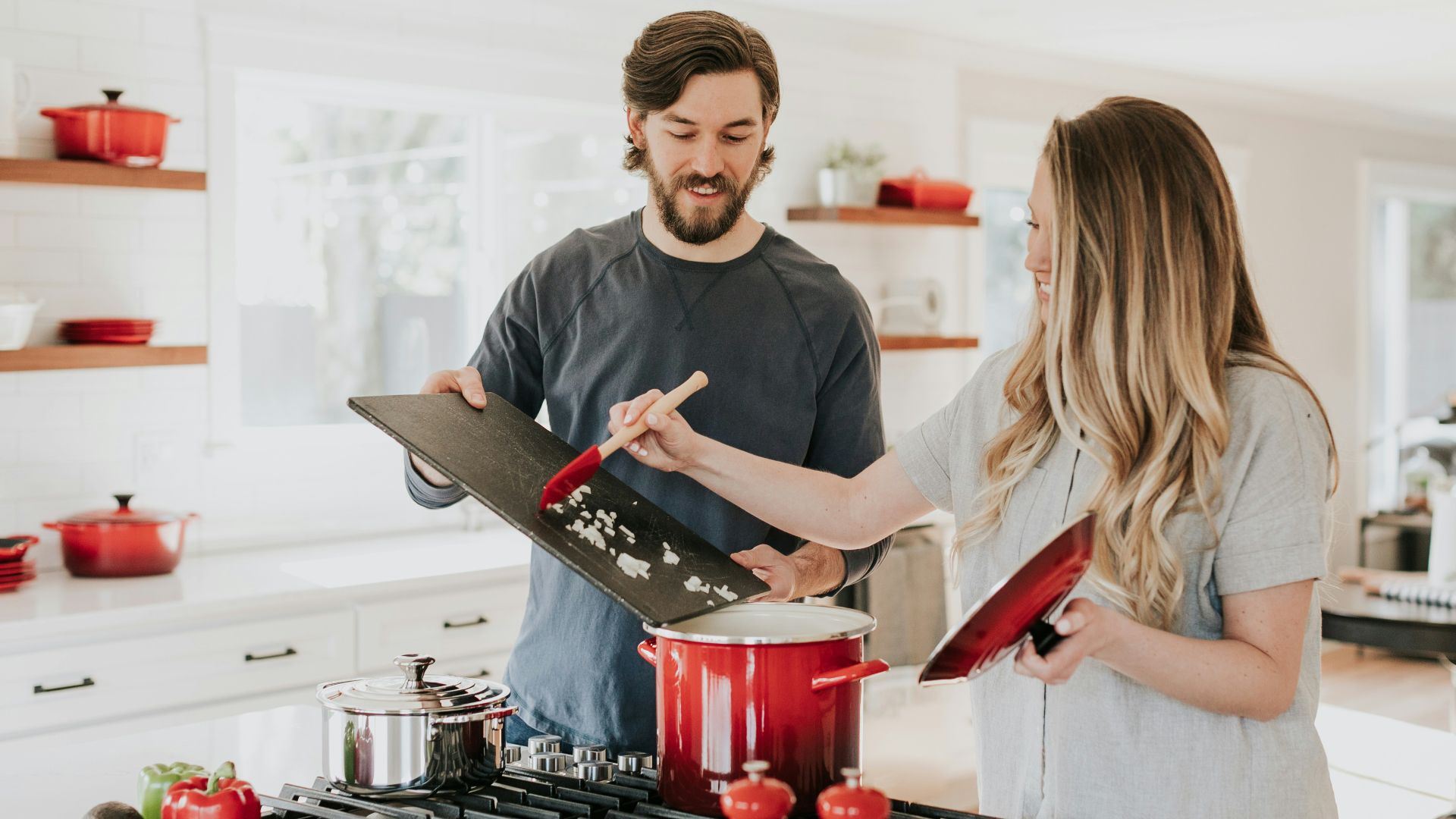 man assisting cooking woman