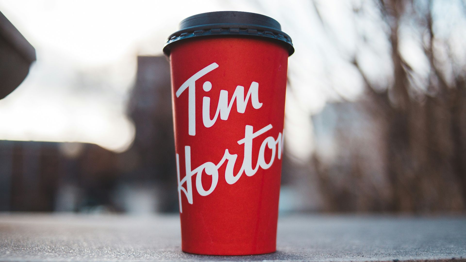 red and white plastic cup on gray concrete floor