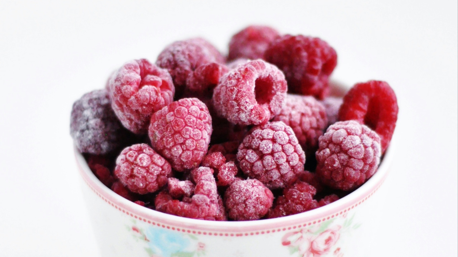 raspberry on white and pink floral ceramic cup