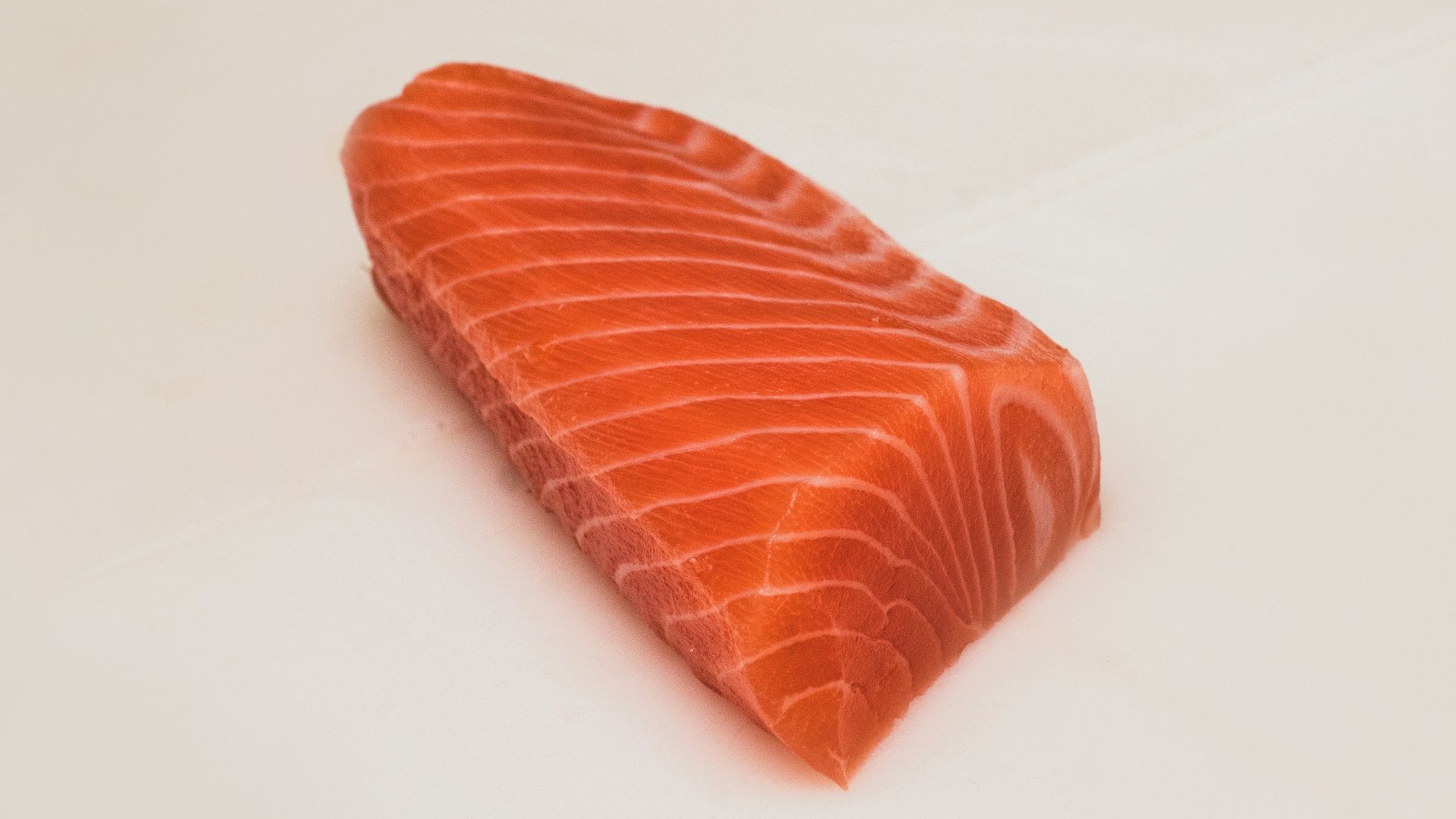 sliced fish meat on white surface