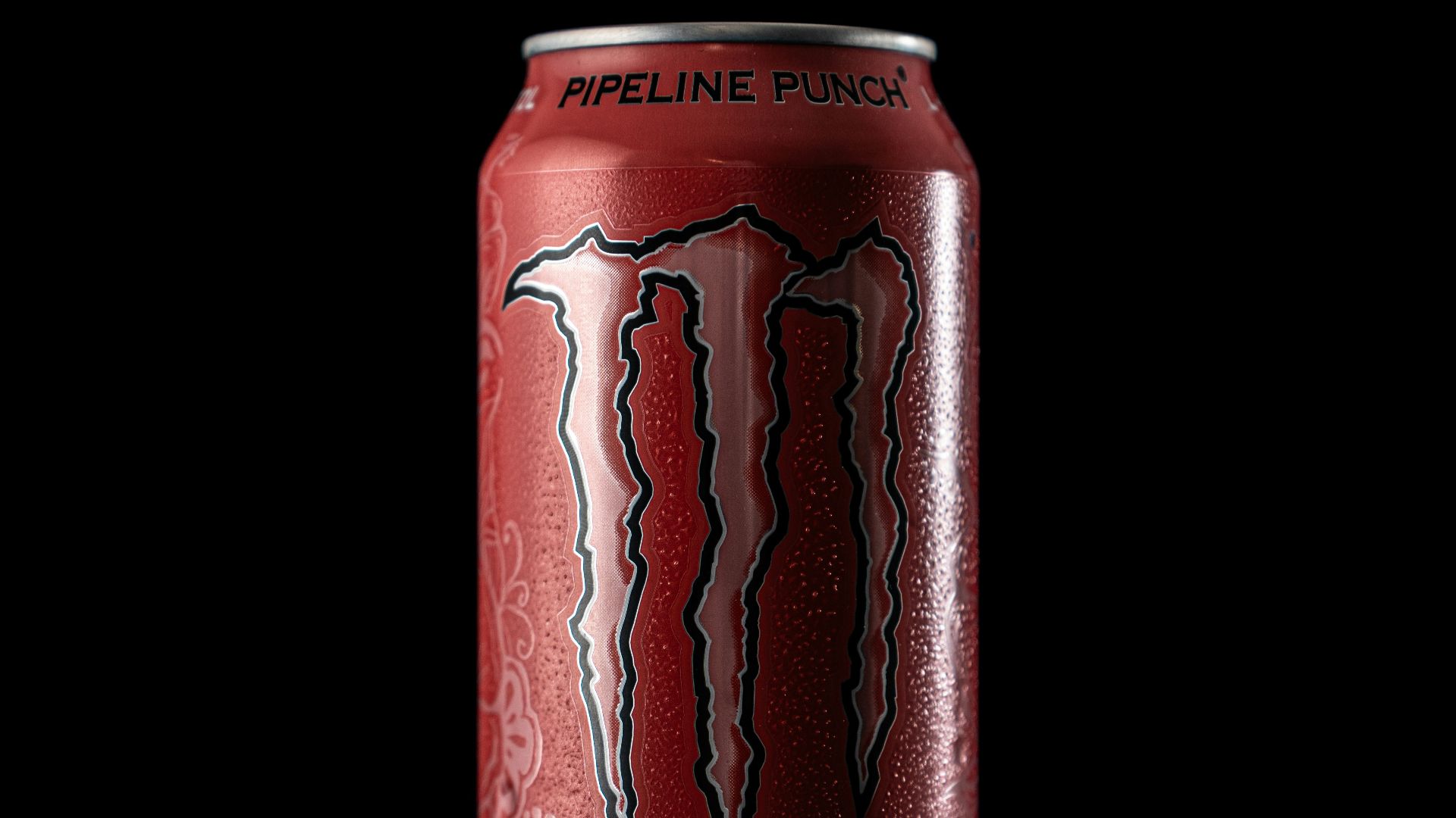 Monster energy pipeline punch can on black background