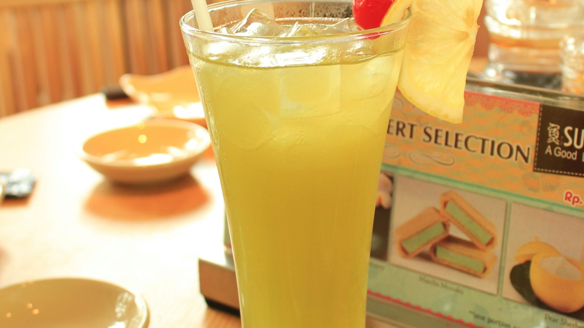 a glass filled with a drink sitting on top of a table