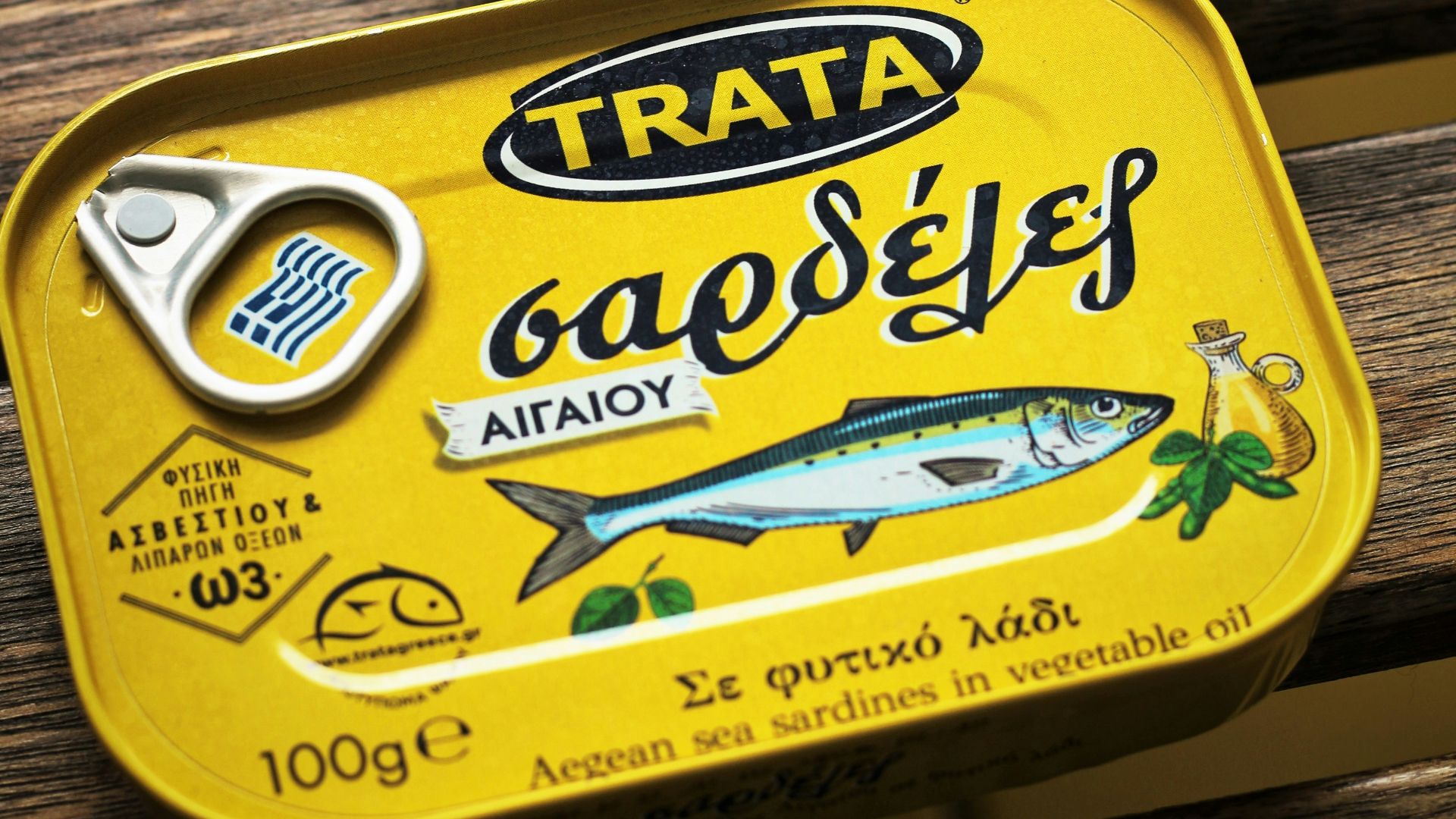 person holding yellow and white can