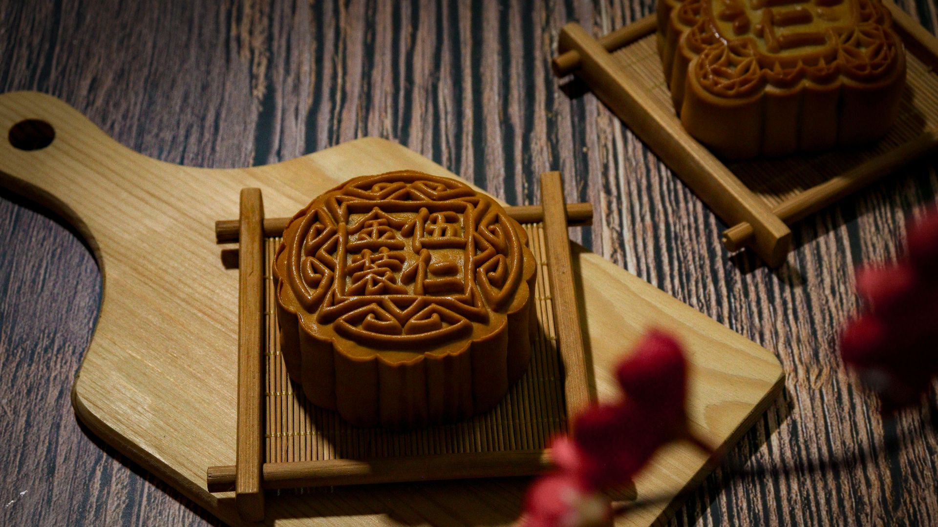 A wooden cutting board topped with a carved wooden object