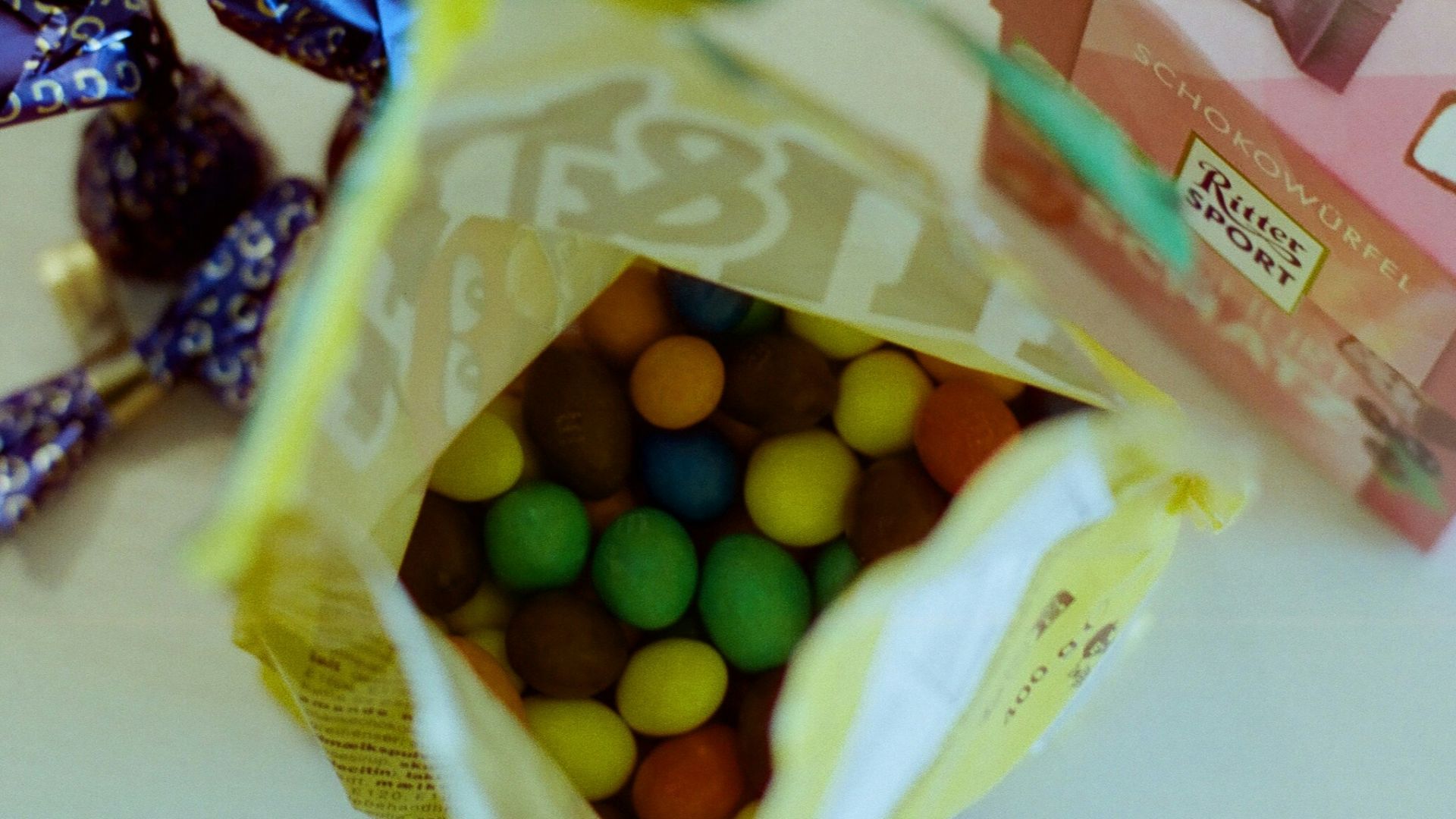 a bag of candy next to a box of candies